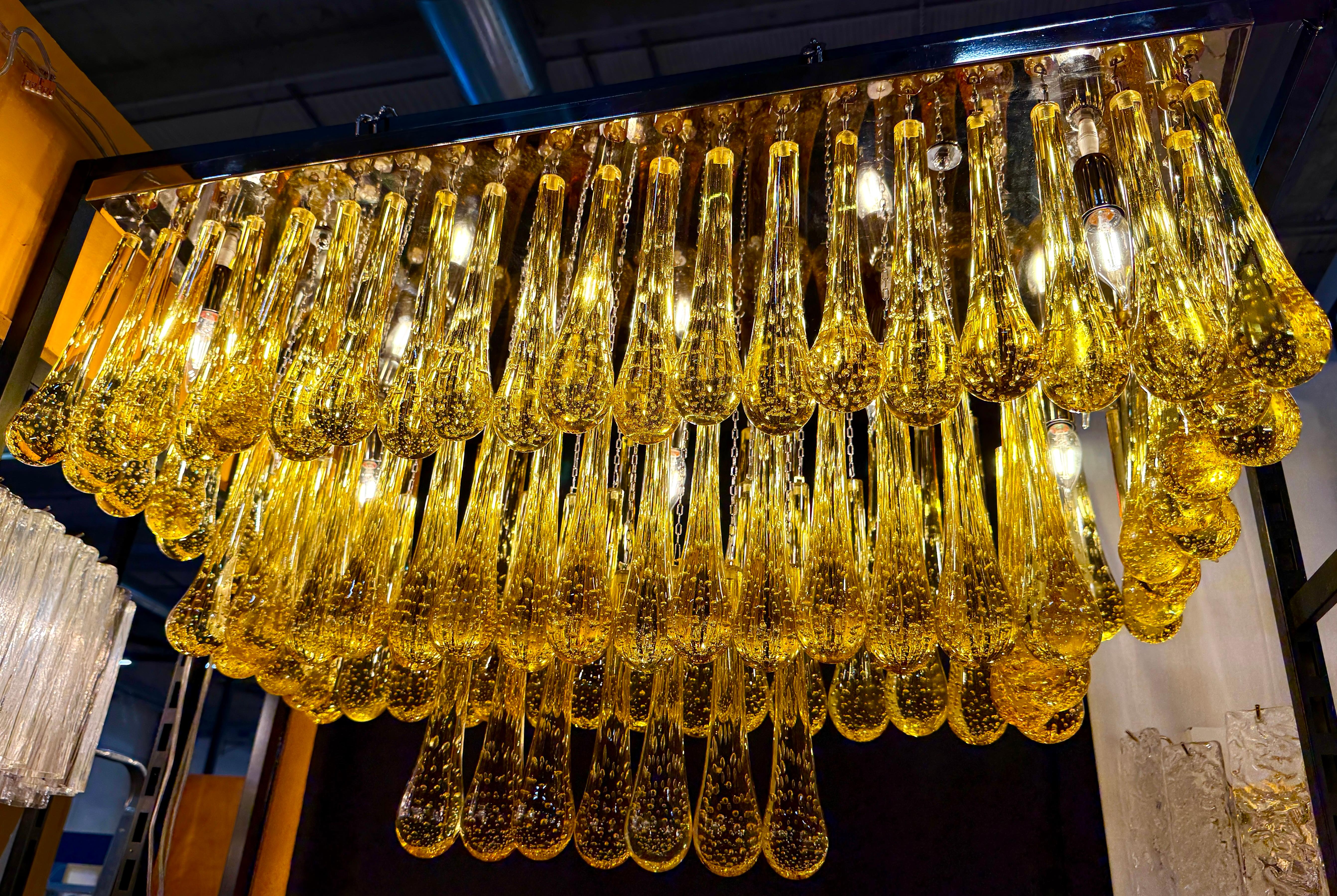 A rain of gold Murano glass tears for a striking  light effect.
 
Nine E 14 light bulbs. \4 watts
We can rewire for your country standards.
 