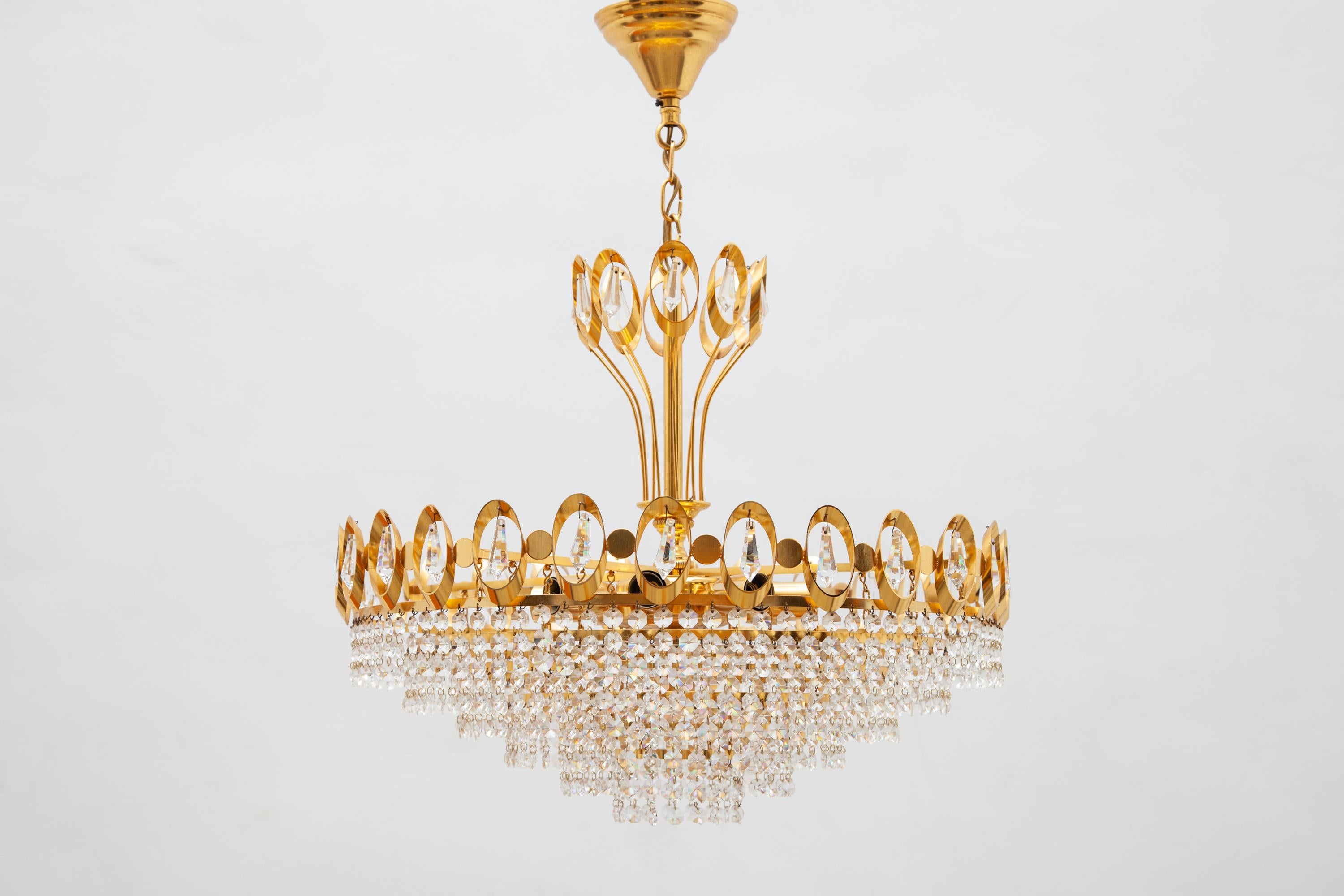 Vintage 1970s chandelier by Palwa, Germany. Six-tiered crystals and gilt brass. 
Lit by 8 bulbs, mint condition.