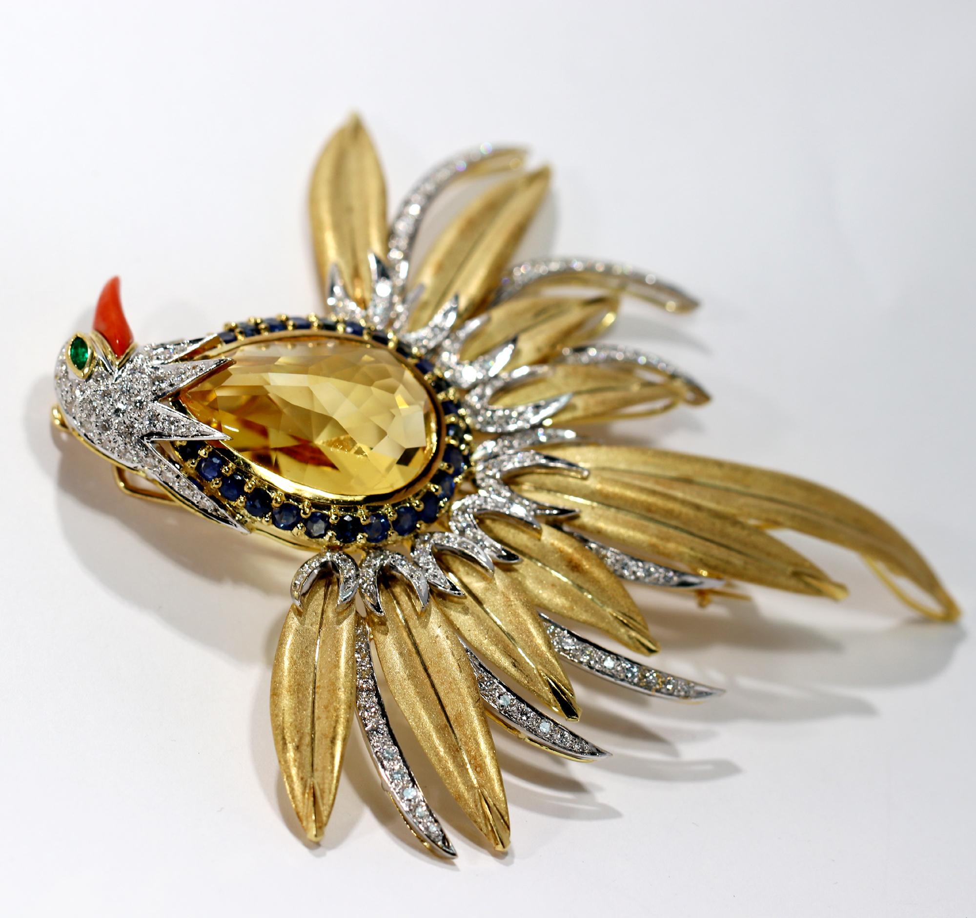 A large  brooch in 18K yellow and white gold, with broad plumage giving the look of a phoenix rising up. The white gold feathers are all pave' set with round brilliant cut diamonds for a total weight of approximately 2.25ct. The belly of this