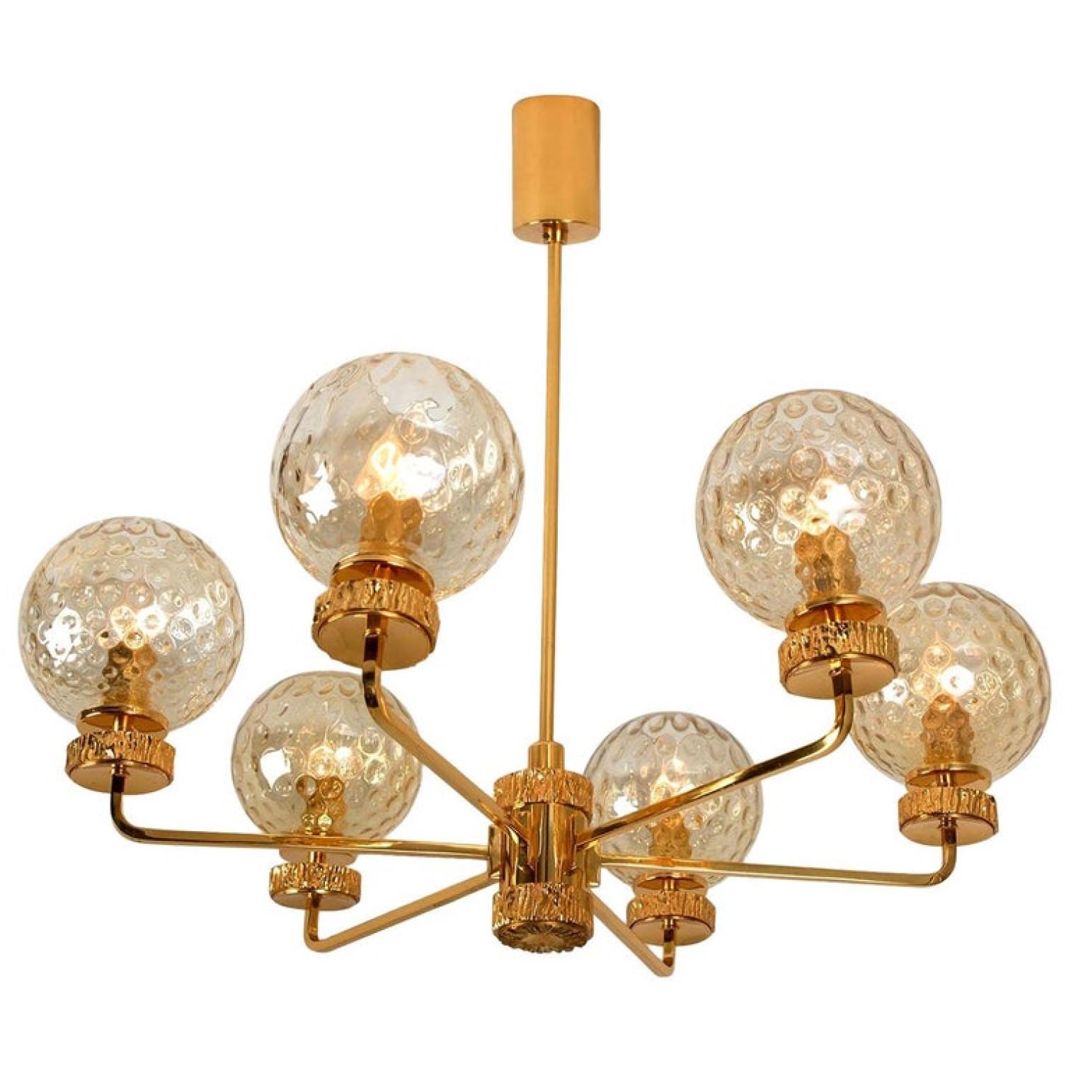 This stunning large pendant chandelier with six textured glass bowls and gold-plated fittings was produced in the 1970s in the style of Brotto. Illuminates beautifully. Elegant and fine, it is comfortable with all decor periods.

This chandelier is