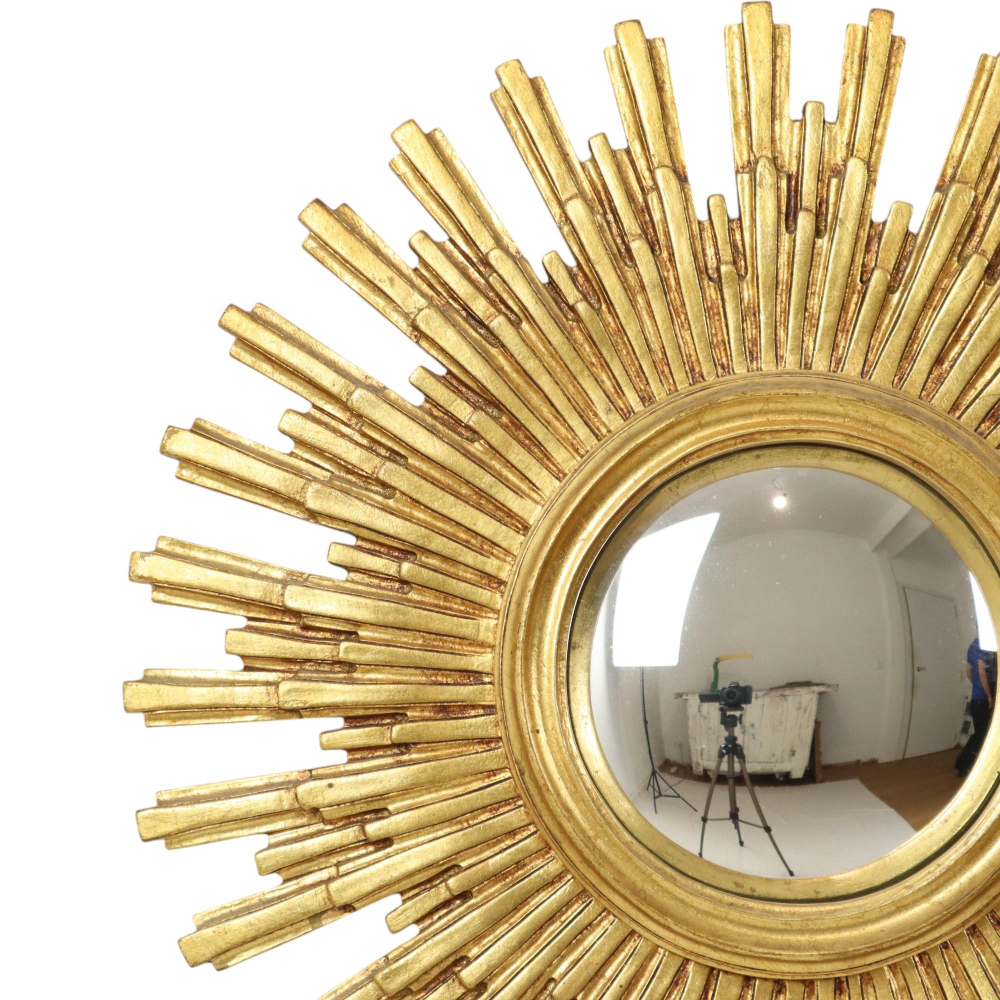 Large gold leaf gilded sun mirror, sunburst mirror made of resin, with a convex mirror, circa mid 20th century, numbered on the back.

Beautiful object with a very nice age patina, the gold leaf has discoloured slightly which makes the rays stand