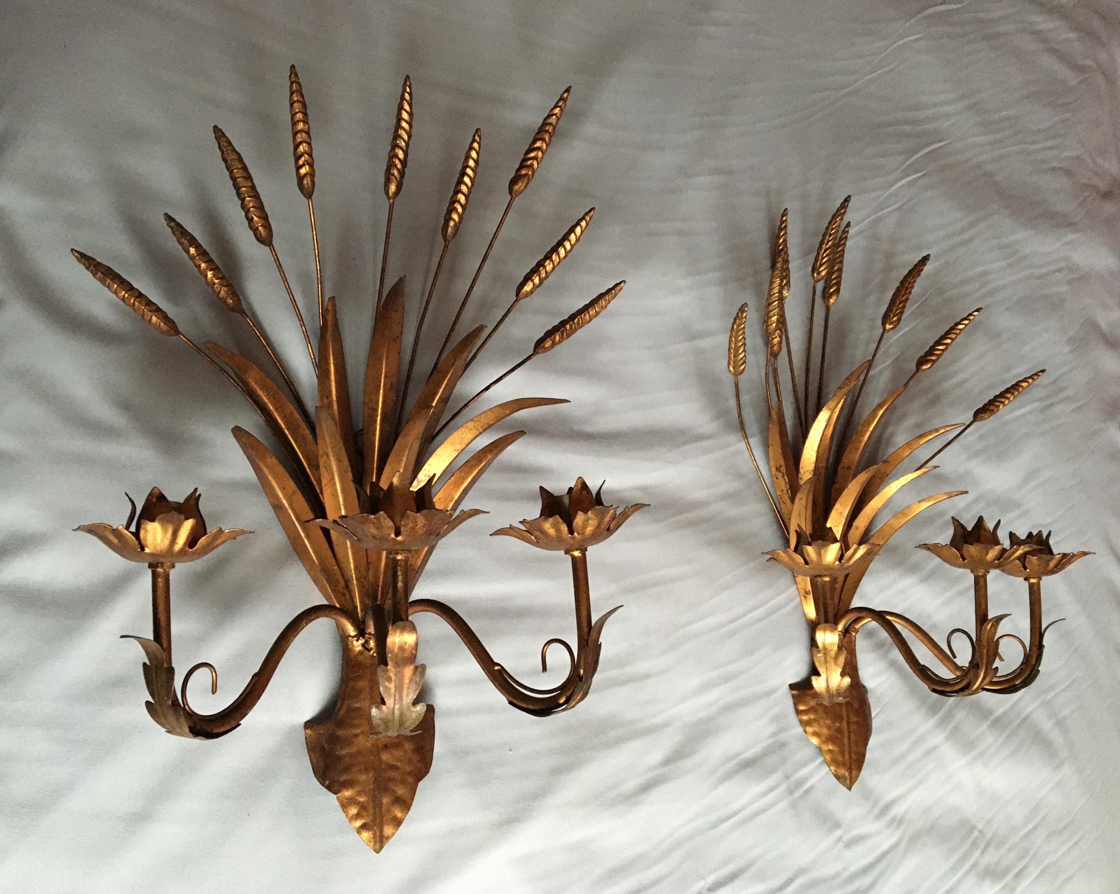 Beautiful and large pair of three-light sconces in gilded wrought metal figuring a sheaf of wheat by Maison Art Flor manufactured in the 1960s, France.

The wall lights are in excellent condition, fit the US standards (small screw bulb holder, 40