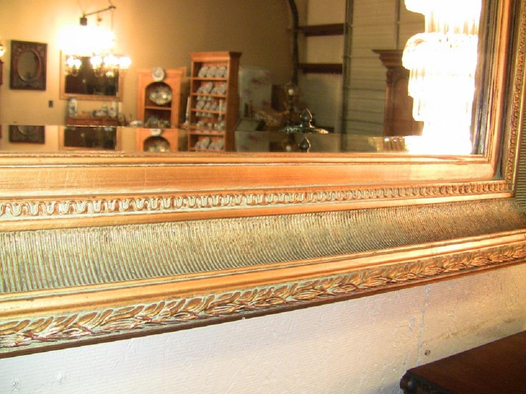 Lovely large gilt framed over-mantle and beveled mirror, in the golden Biedermeier style!

It has lovely carved edges and a gorgeous frame.

Probably mid-20th century, but highly decorative!

A statement piece in any hallway!