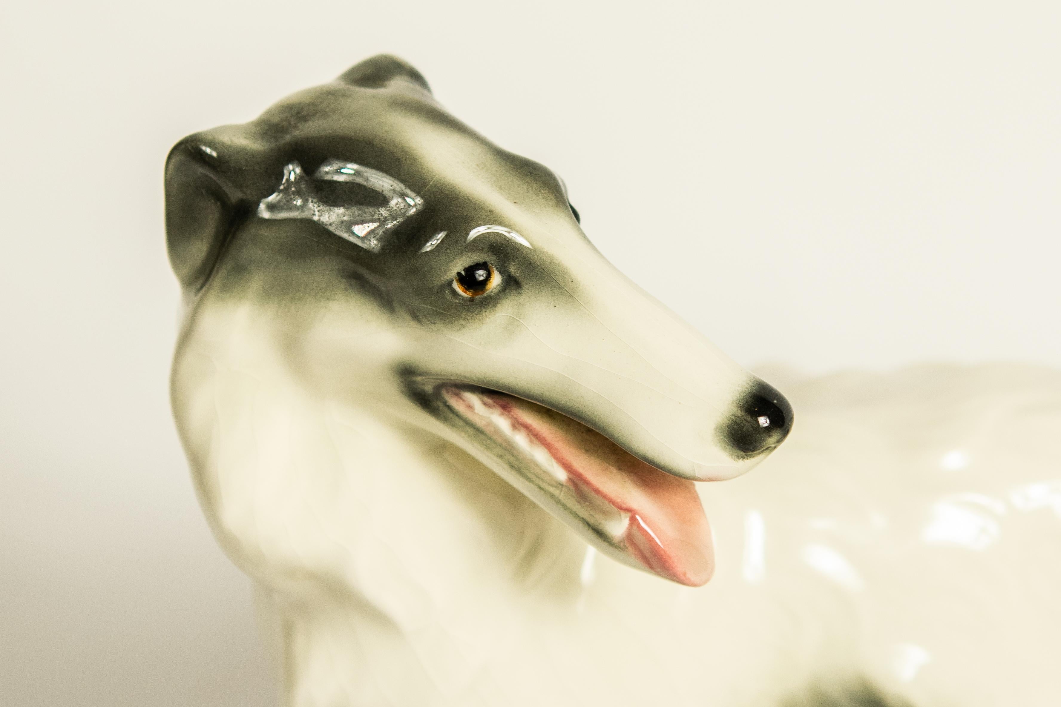 Goldscheider porcelain dogs. Features a pair of Borzoi with one lying down and the other standing. Marked Goldscheider Austria. Measures: 12