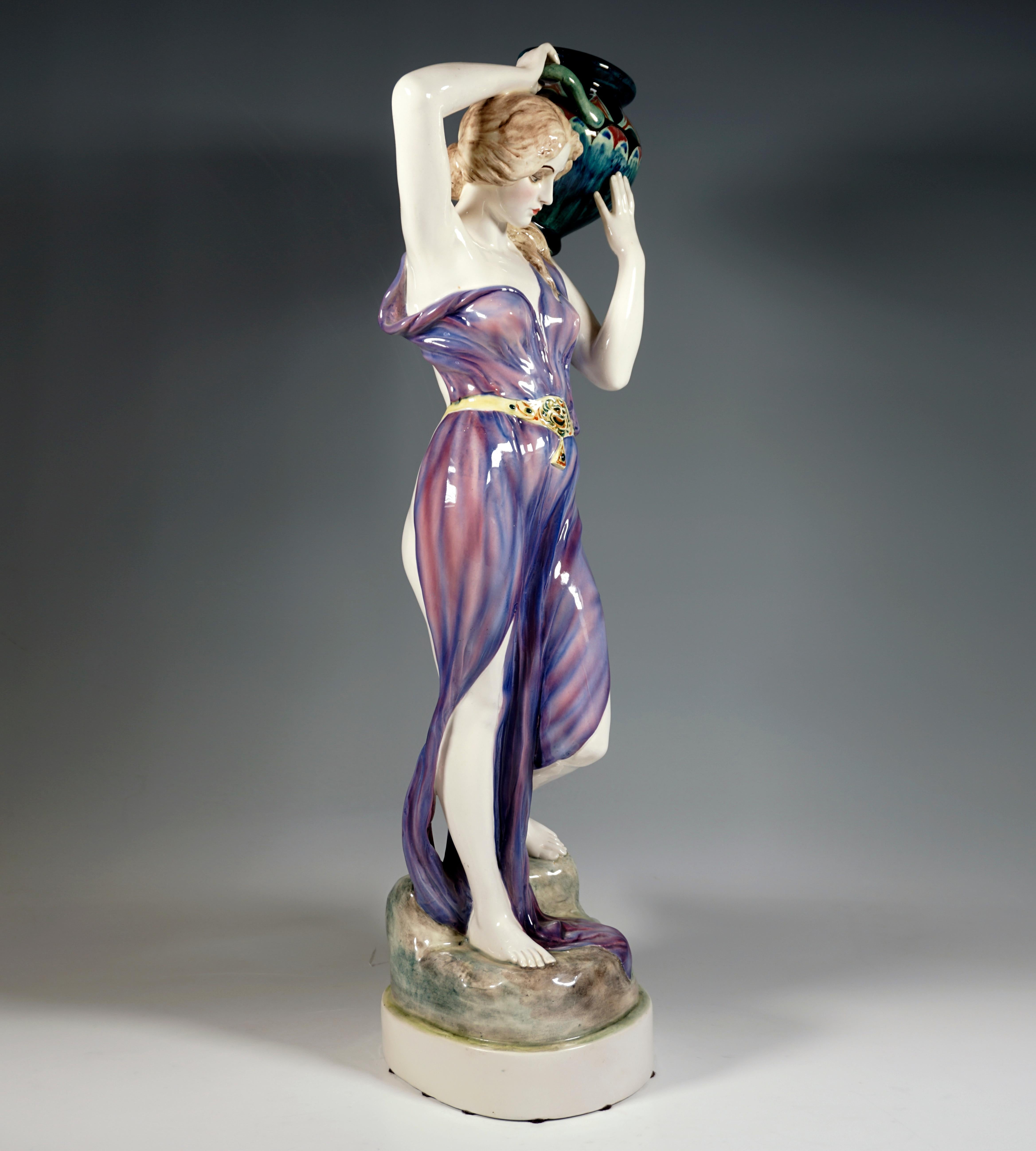 Very large and rare Goldscheider ceramic figurine from the 1920s:
Art Déco execution of an Art Nouveau design around 1902: young lady with her hair tied at the nape of her neck and lying forward over her shoulders, in a softly falling, transparent