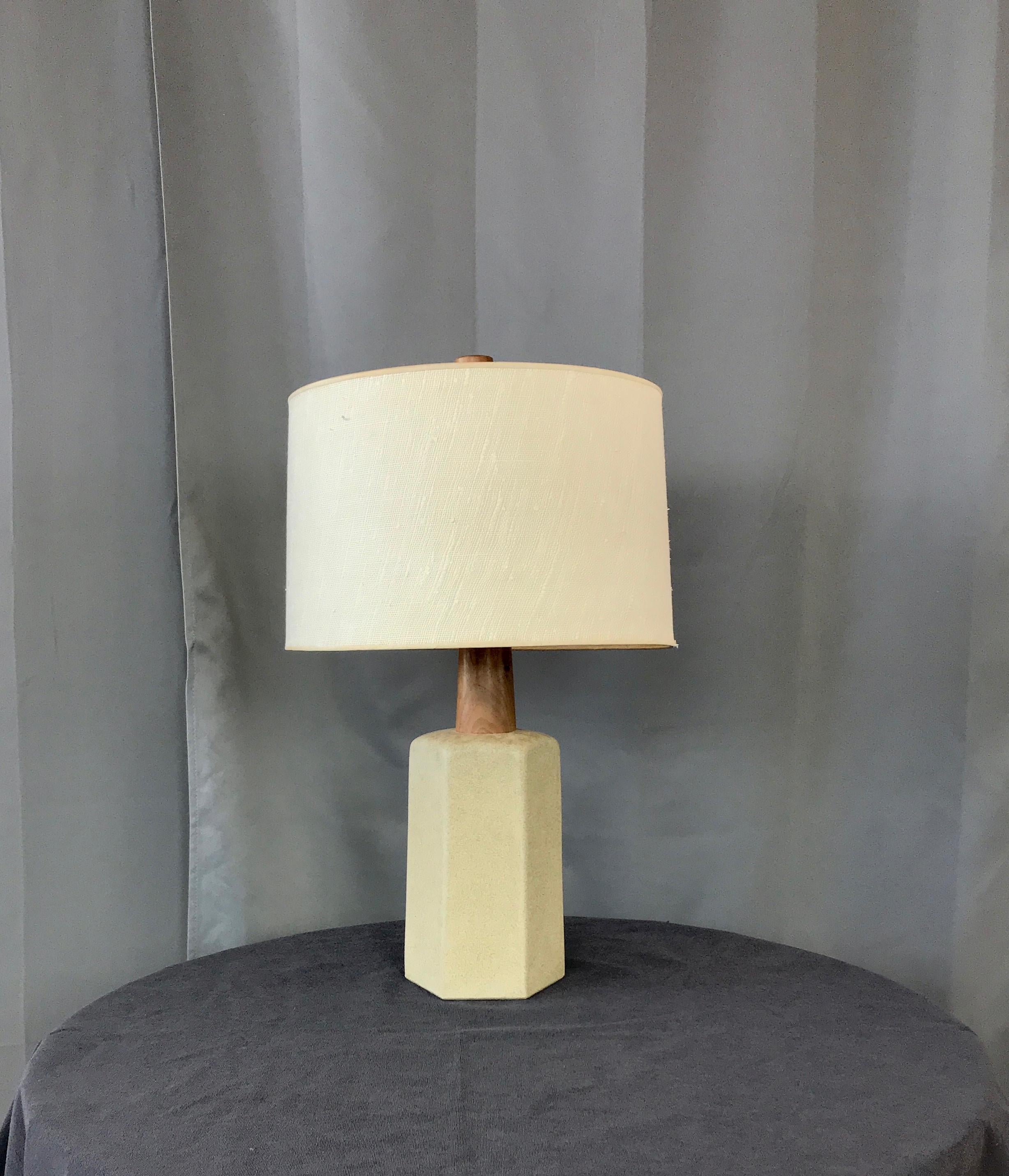 A large Gordon and Jane Martz table lamp for Marshall Studios. Signed on the back side of the lamp.
With it's original shade and walnut final. Nice hexagon shape base in a speckled oatmeal like glaze, capped with a walnut neck. 

It's 26.25in to