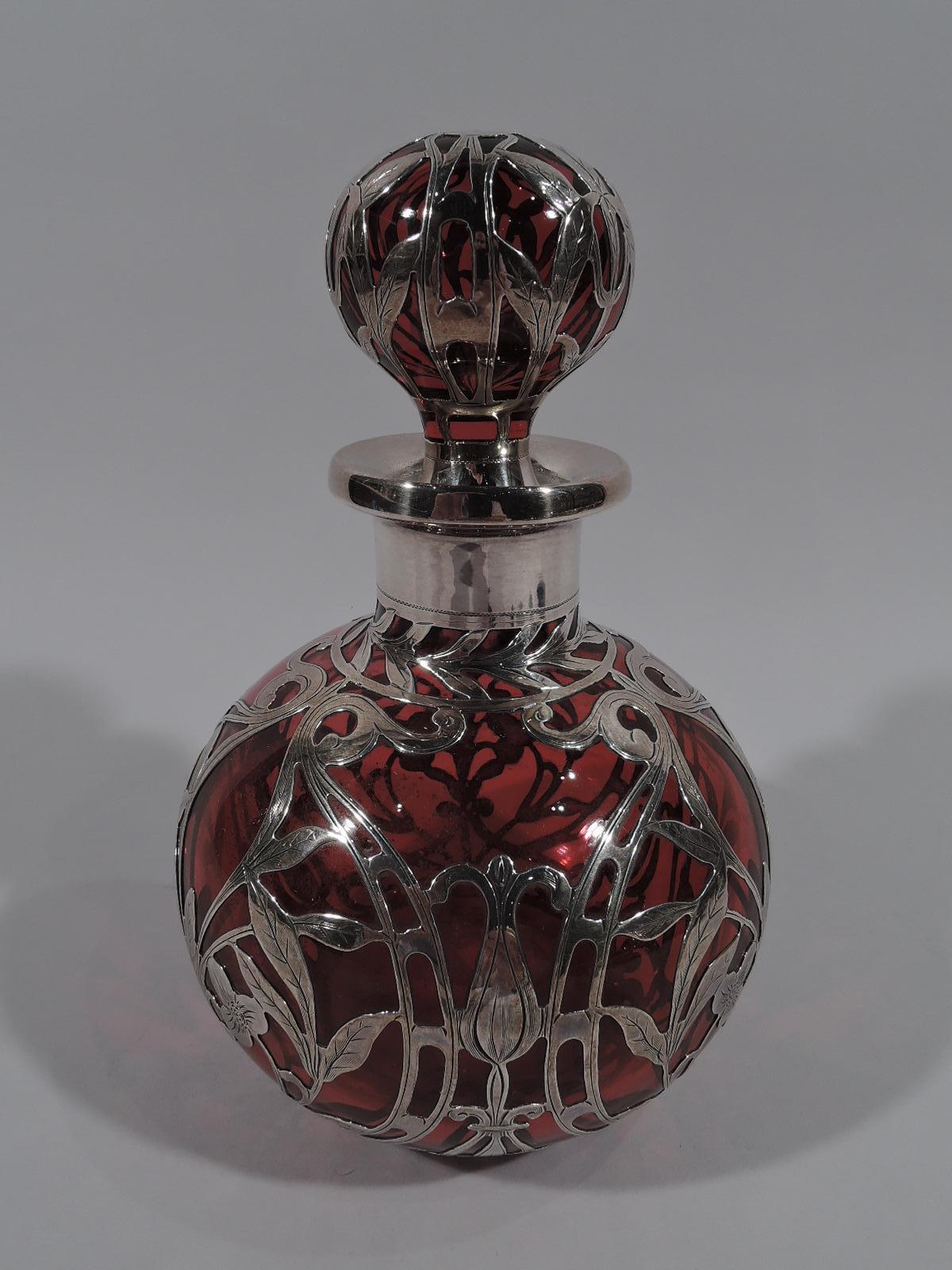 Large Art Nouveau red glass perfume with silver overlay. Made by Gorham in Providence, circa 1910. Globular with short neck and everted rim in silver collar. Ball stopper. Symmetrical overlay in fluid whiplash tendrils and stylized leaves. Elongated