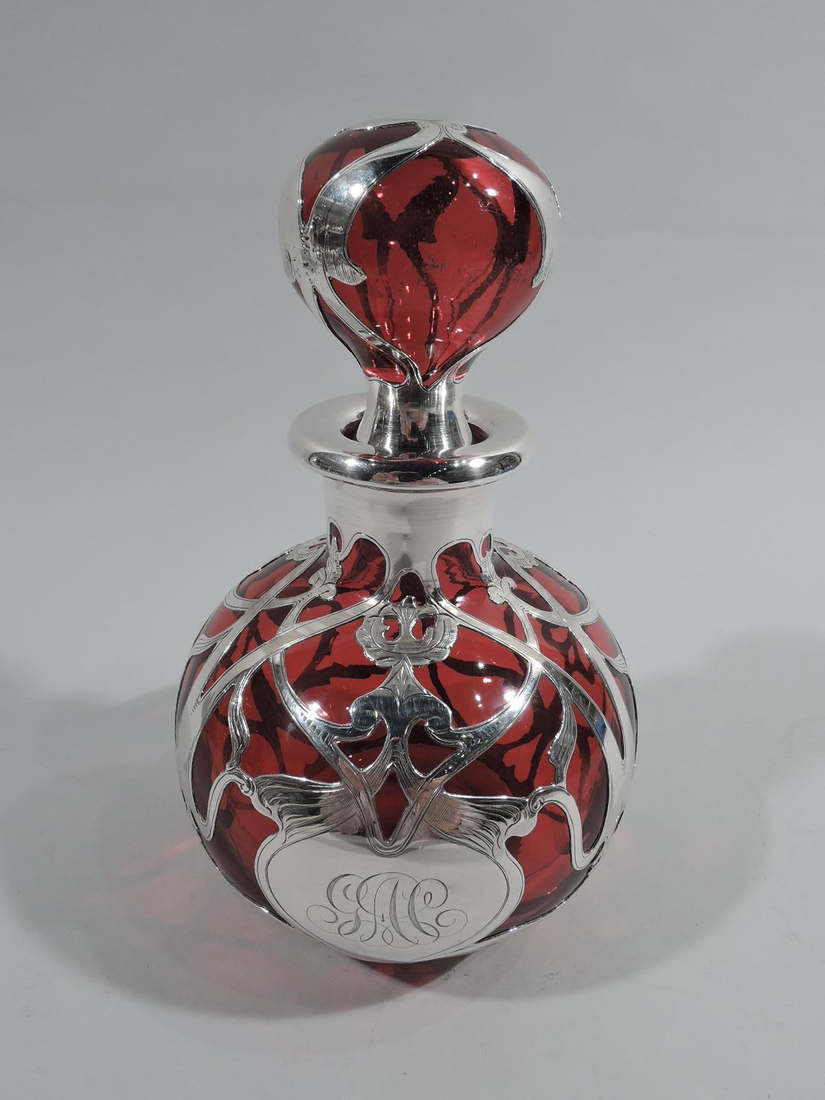 Large turn-of-the-century Art Nouveau glass cologne bottle with engraved silver overlay. Made by Gorham in Providence. Globular with everted rim. Ball stopper. Loose and interlaced scrolled overlay with flower heads and leaves in symmetrical
