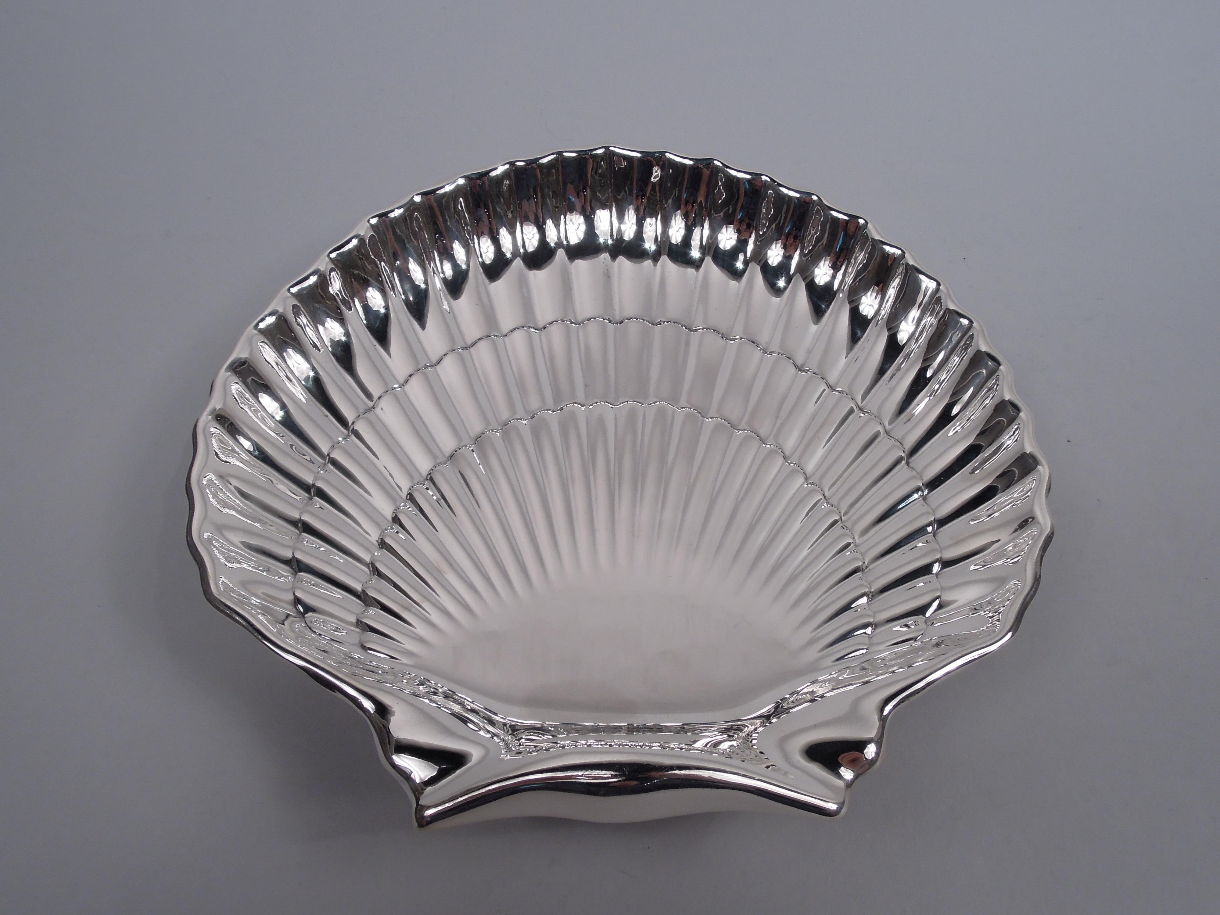 Large sterling silver scallop shell. Made by Gorham in Providence in 1947. Traditional form with dense and tiered flutes and 2 ball supports. Fully marked including maker’s stamp, date code, and no. 40617. Weight: 17 troy ounces.  