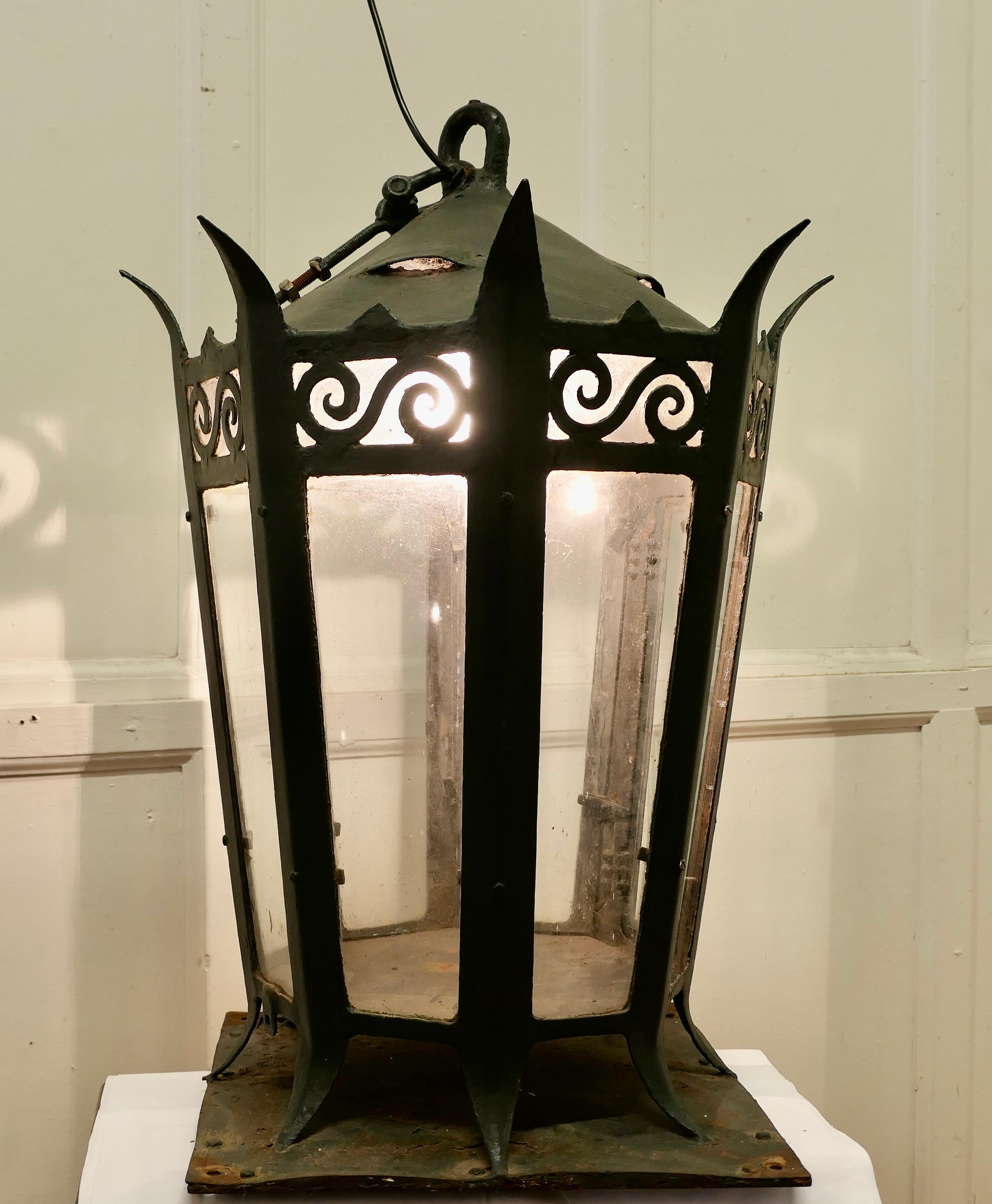 Large Gothic Iron Porch or Gate Post Lantern 

This a Large and Heavy Lantern is it is very Gothic in design it has 8 flat sides a domed top and it is decorated with fierce looking spikes, it would have formerly been lit with oil now it has a