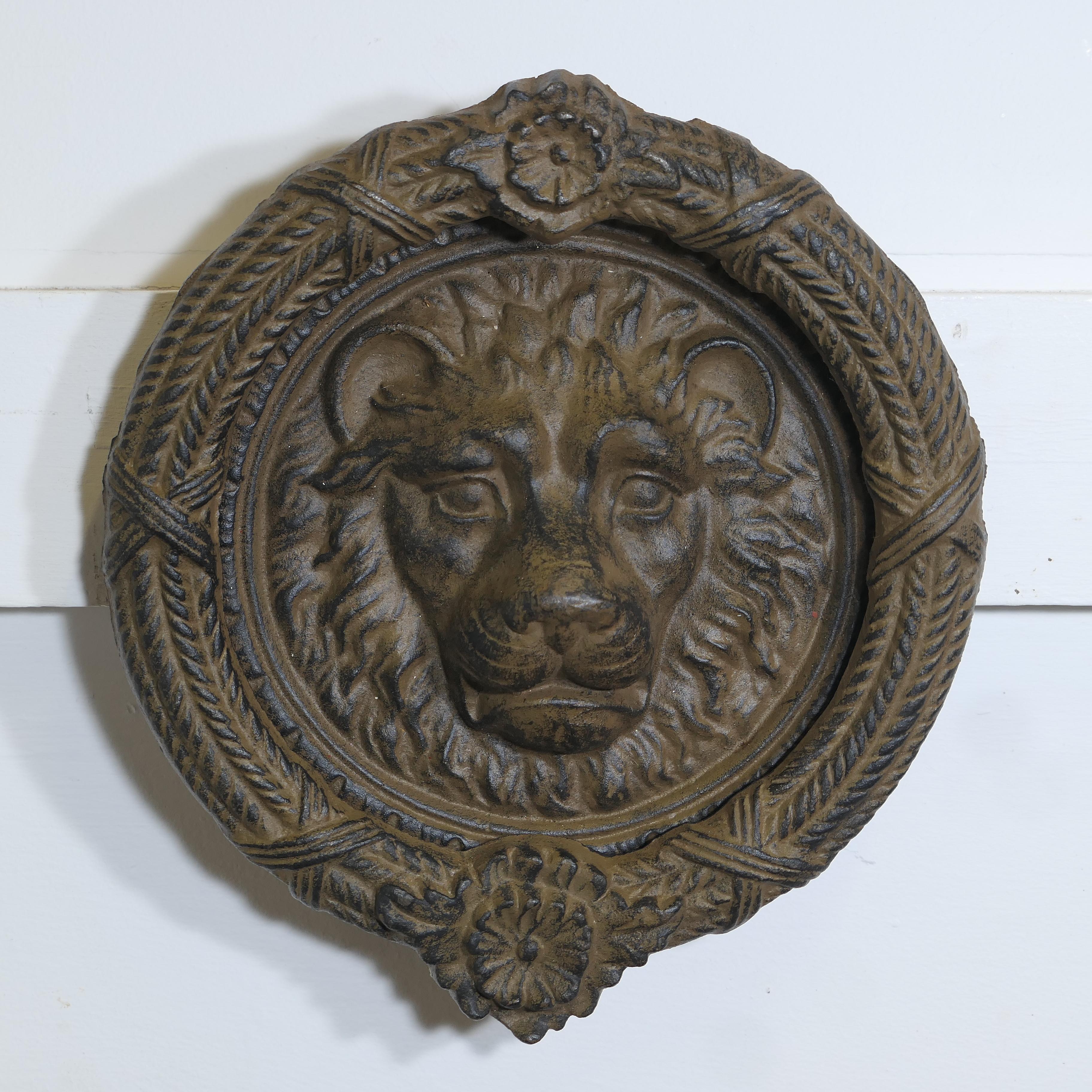 Large Gothic Lion’s Mask Iron Door Knocker 

This is a superb door knocker, the handsome Lion’s Head is  at the centre  and the heavy outer ring lifts and lands on the striking plate 
The door knocker is in good condition it measures 11” in diameter