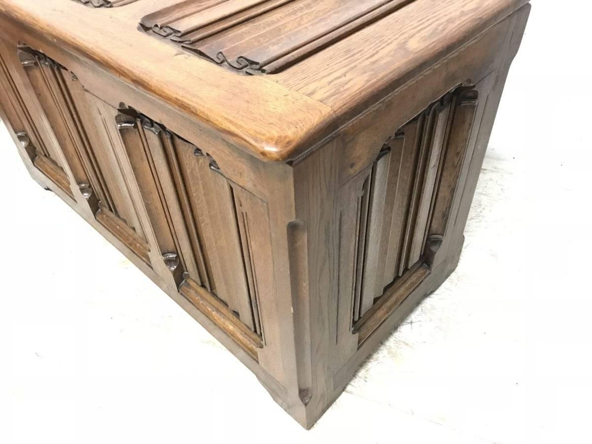 Large Gothic Revival style carved oak blanket chest in the style of A.W.N. Pugin. This has been very well made probably around the turn of the century from original Gothic Revival deeply carved linen fold panels and period oak. The hand caved linen