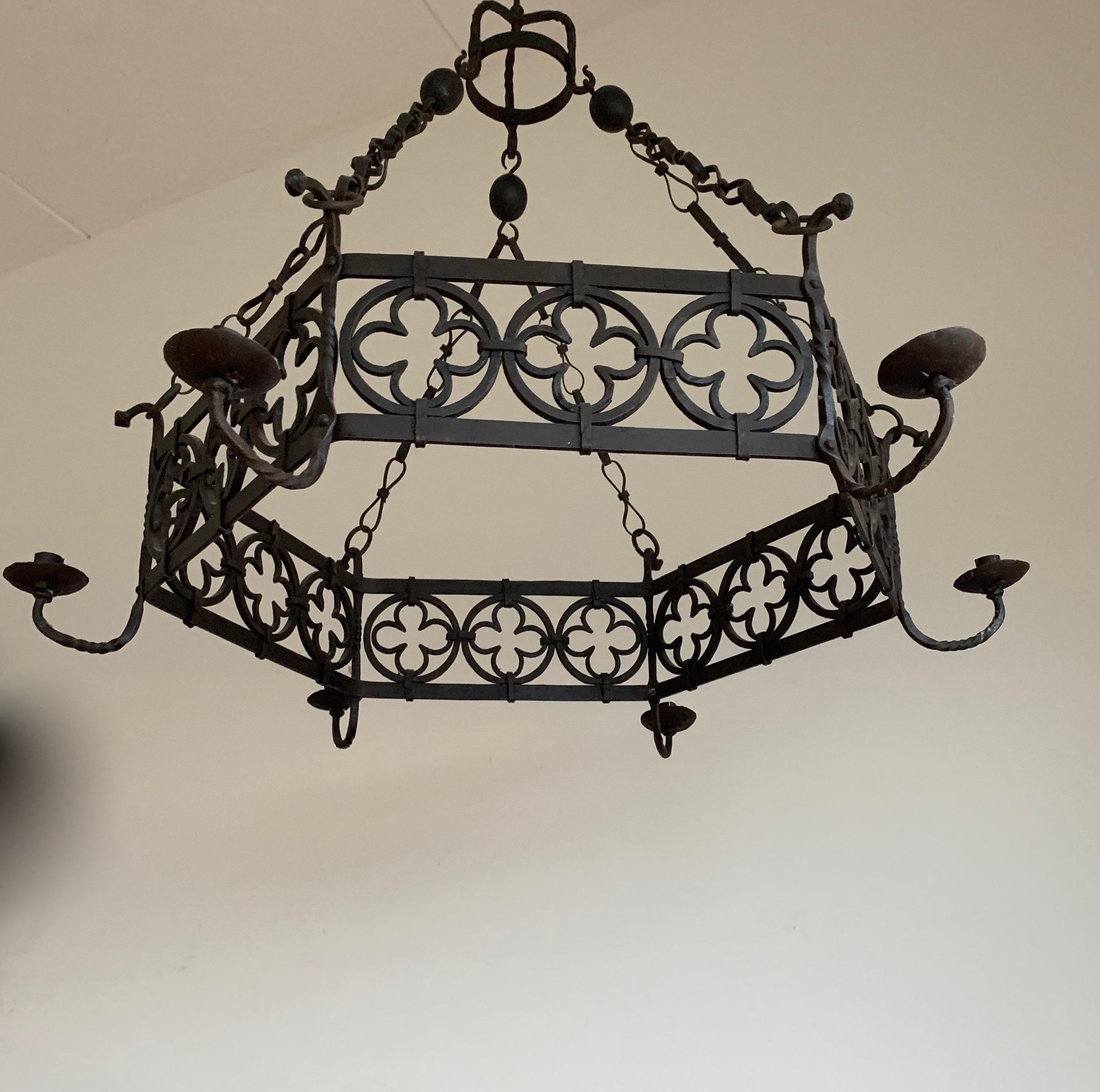 Great quality workmanship, forged in fire Gothic Art candle chandelier or pendant light.

This beautiful quality and all hand forged chandelier comes with clearly visible, Gothic quatrefoil elements which certainly lifts it above the average. In the