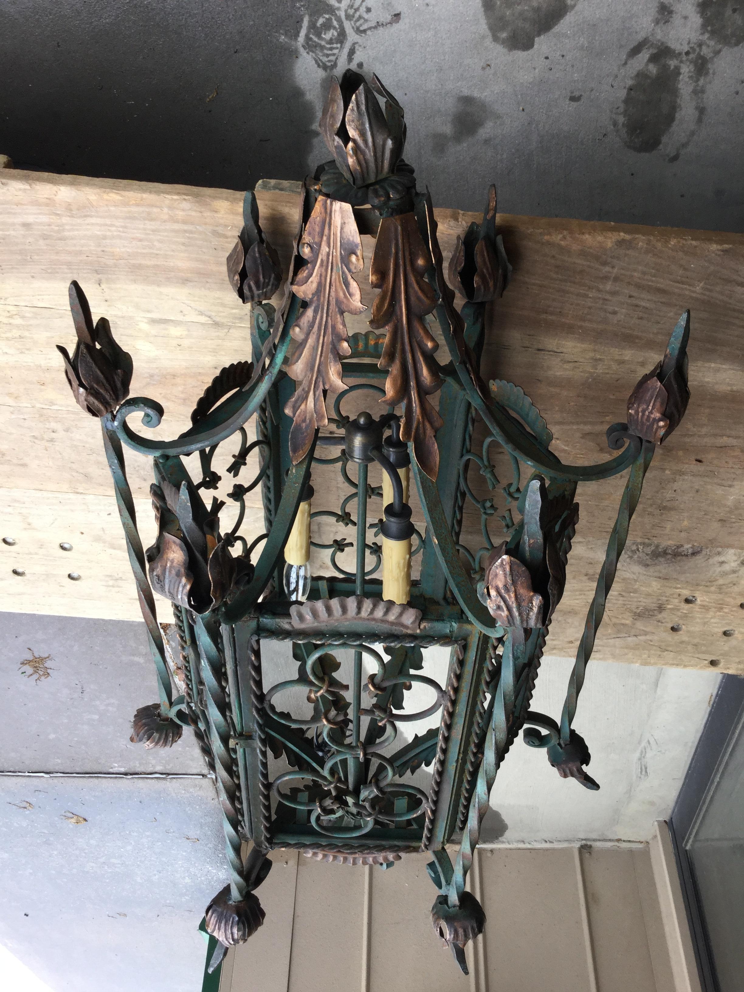 Gothic style wrought iron lantern in dark green with gilt accents. This heavy gauge lantern has been newly wired and includes extra wire. The color could be easily changed to black.
 