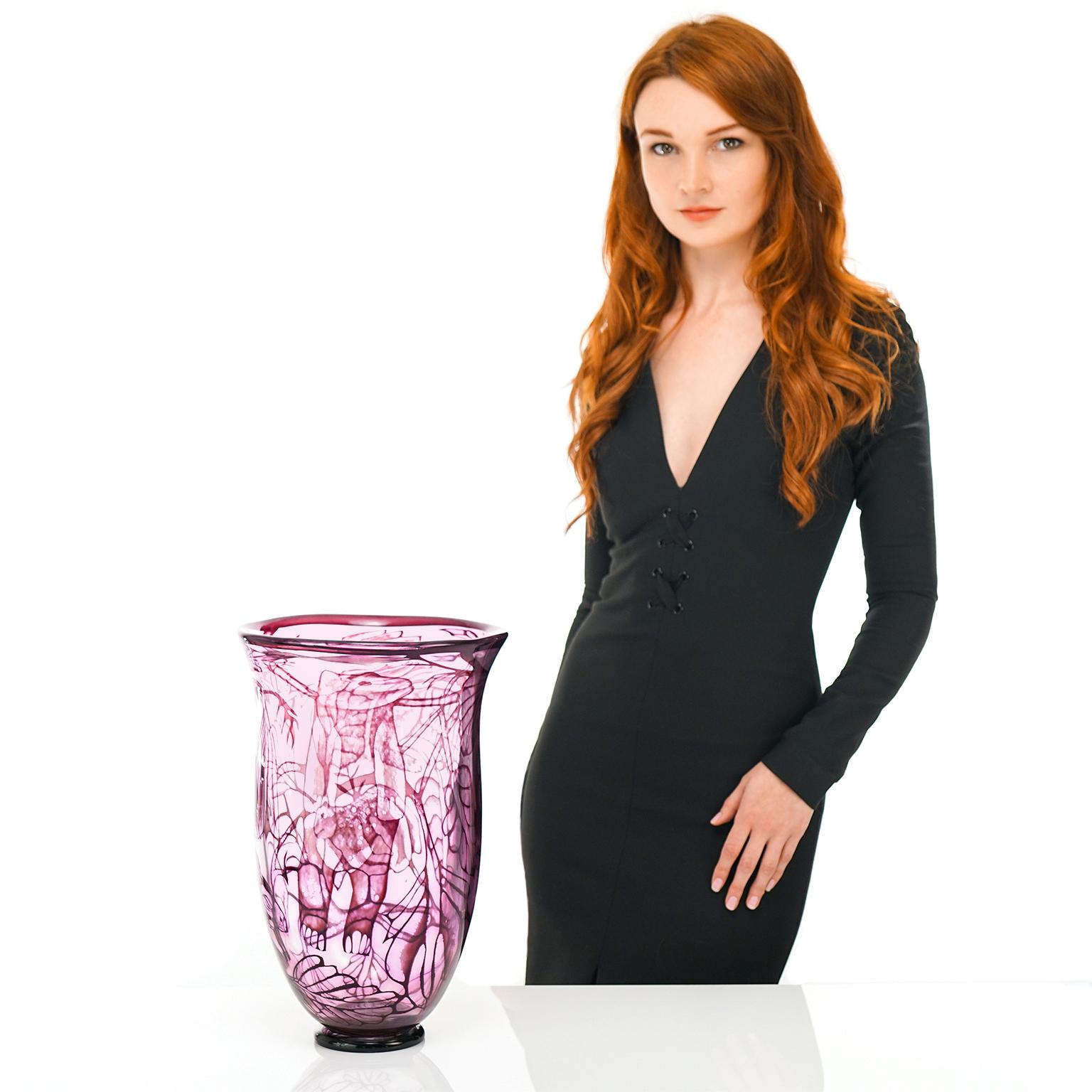 By Eva Englund for Orrefors, Sweden, circa 1976. This spectacular 15 inch tall vase by the renowned glass designer, Eva Englund for Orrefors, features a whimsical woodland motif in delicate pink, lavender and purple hues. Fabricated using the