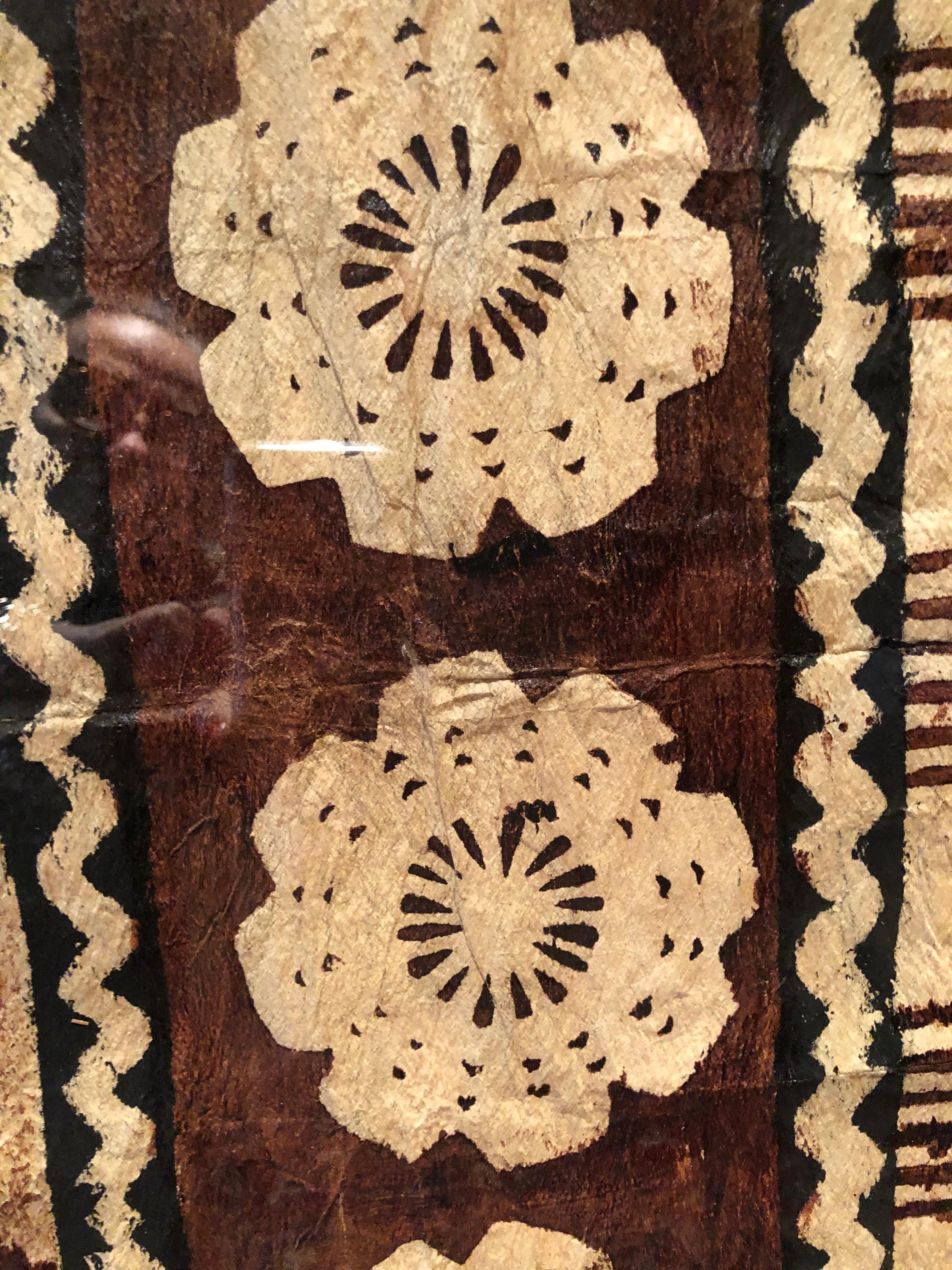 Incredible painting on tree bark from Fiji where the bark cloth is historically beaten from fibrous vines and then painted. The various designs reference the natural environment. Custom framed.