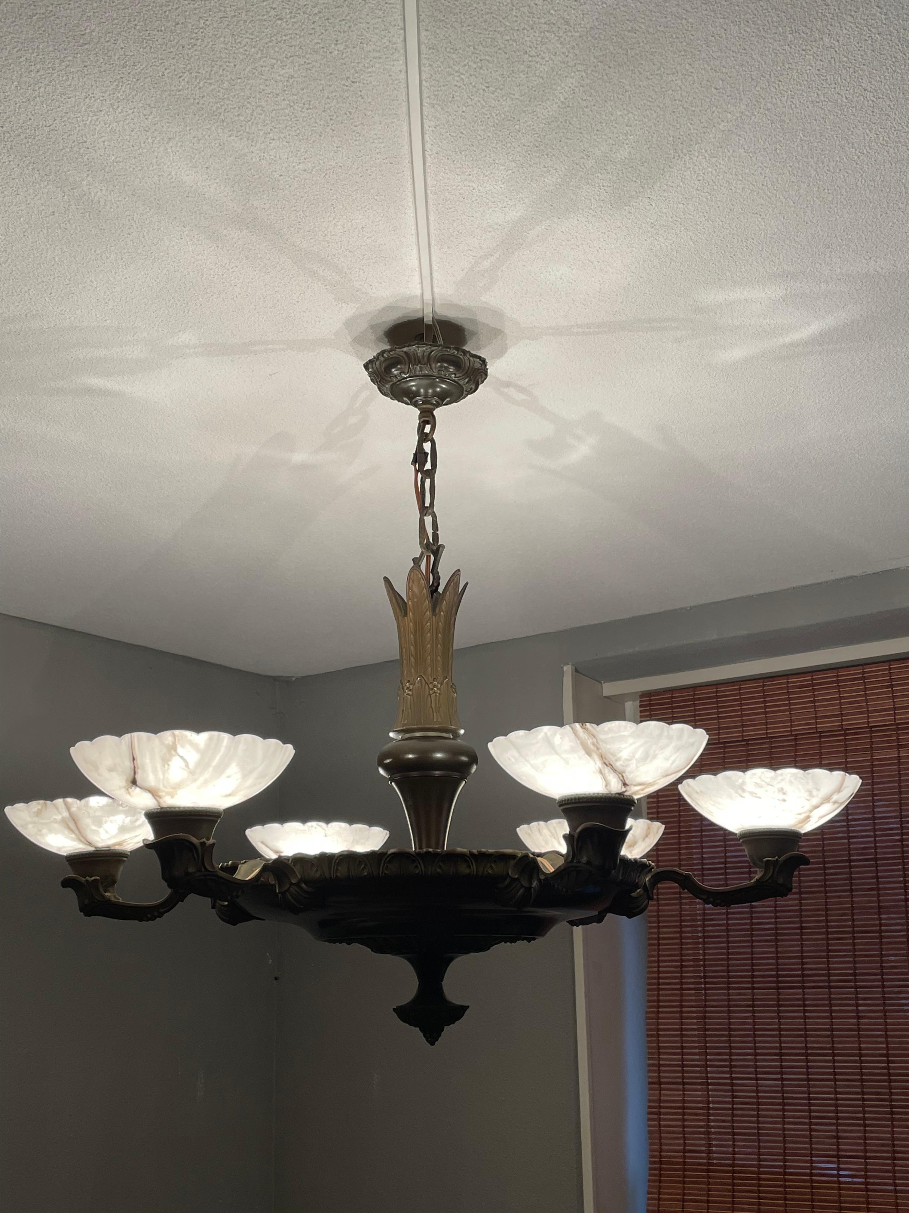 Striking and exclusive 1910s brass and alabaster light fixture for the perfect atmosphere.

If you are looking for a remarkable light fixture to grace your living space then this antique Art Deco era chandelier could very well be the one. The