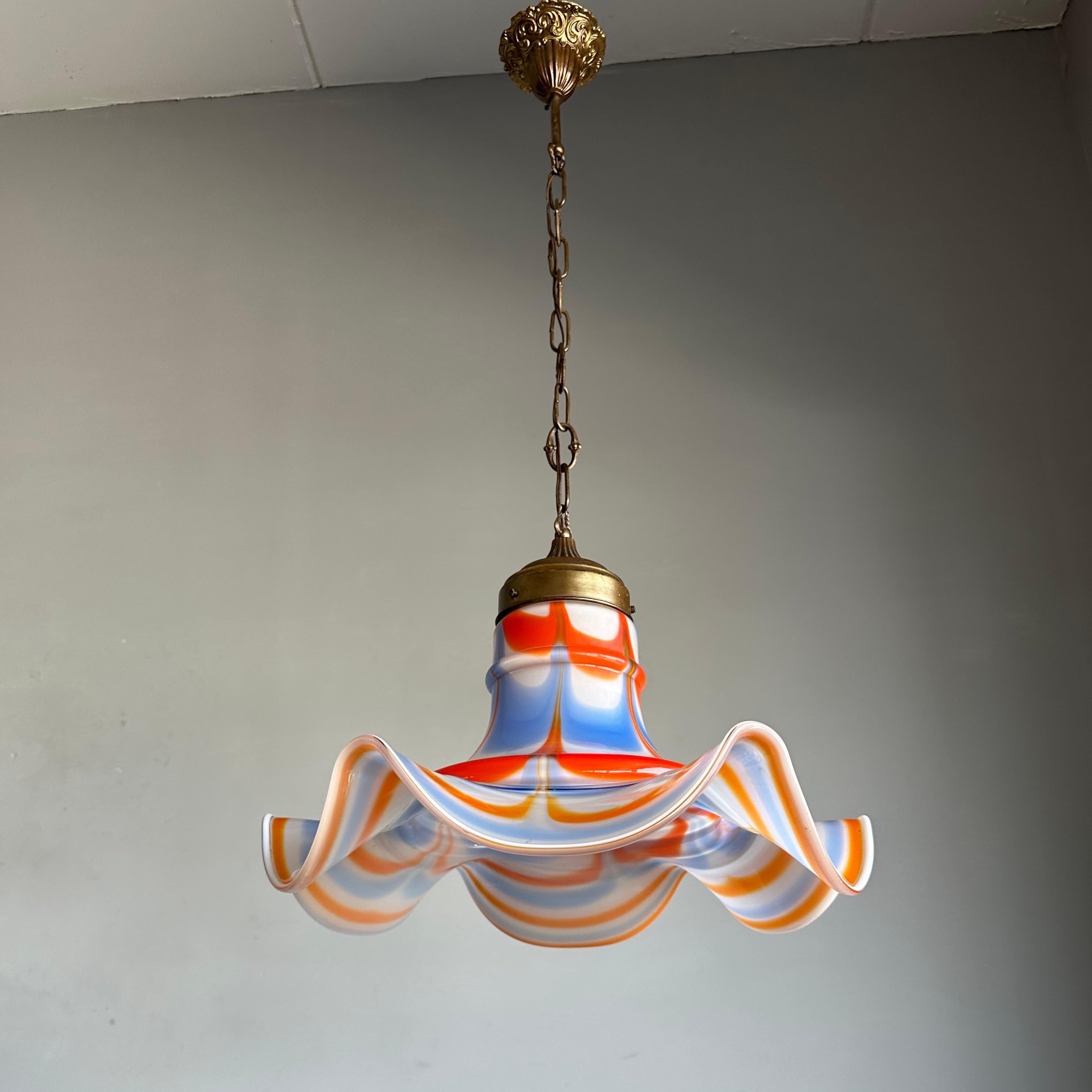 A one-of-a-kind and midcentury mouthblown, glass light fixture.

This elegant Murano glass pendant from the 1950s is a truly exquisite lighting statement and she is in good original condition. If you are looking for a pendant to bring some extra