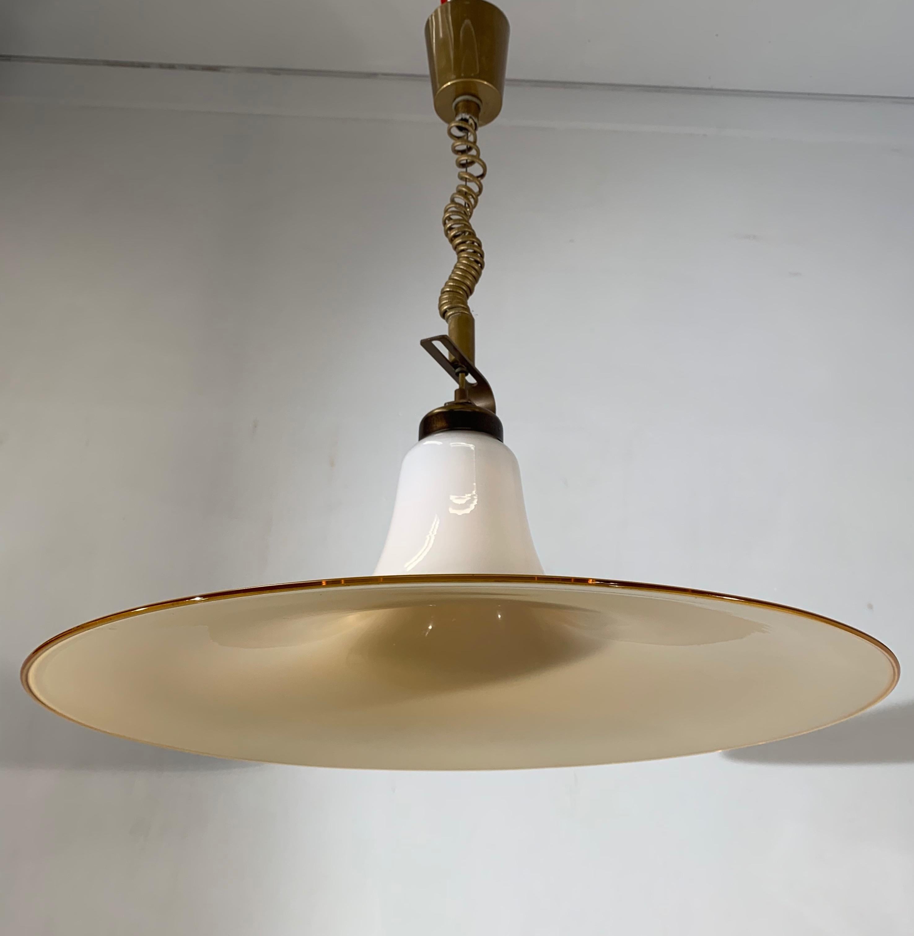 Wonderful midcentury chandelier.

If you are looking for a rare and stylish mid-20th century fixture to grace your home then this handcrafted Italian light could be perfect. One person might see an upside down vortex of liquid glass in this shade,