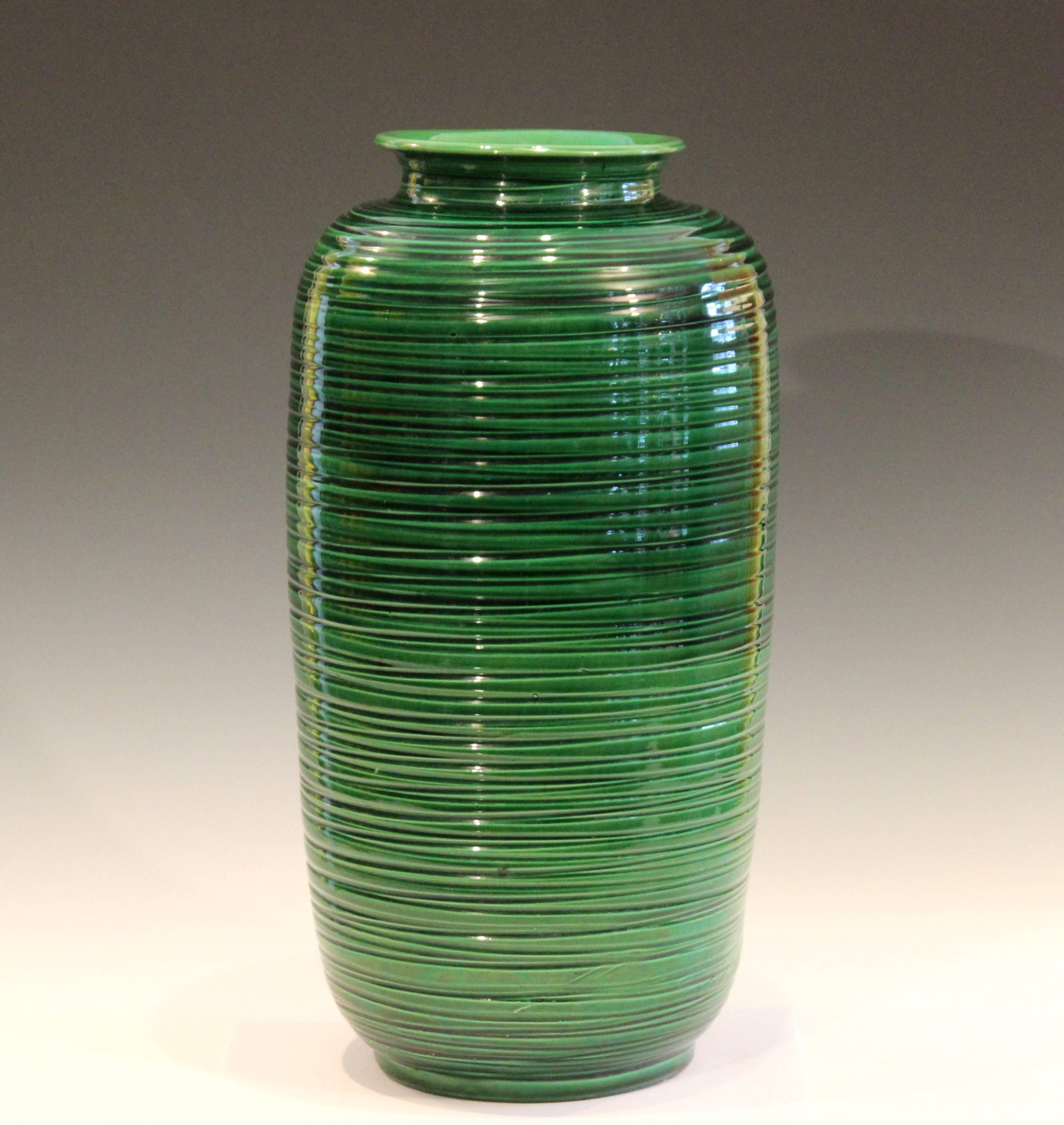 Large Awaji pottery canister form vase with accentuated ribs and deep green glaze, circa 1910s. Measures: 17 3/4
