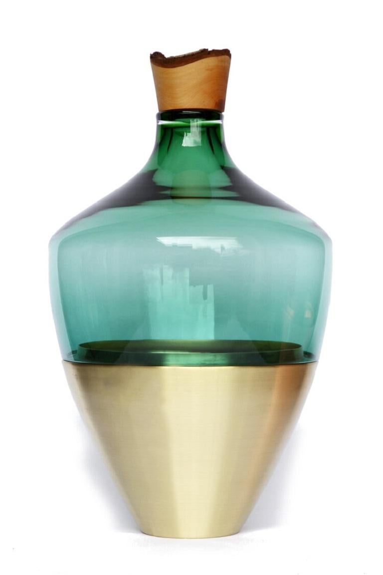 Large green blue India vessel II, Pia Wüstenberg
Dimensions: D 30 x H 55
Materials: glass, wood, metal
Available in other metals: brass, copper

Handmade in Europe, by individual craftsmen: handblown glass (Czech Republic), hand spun metal,