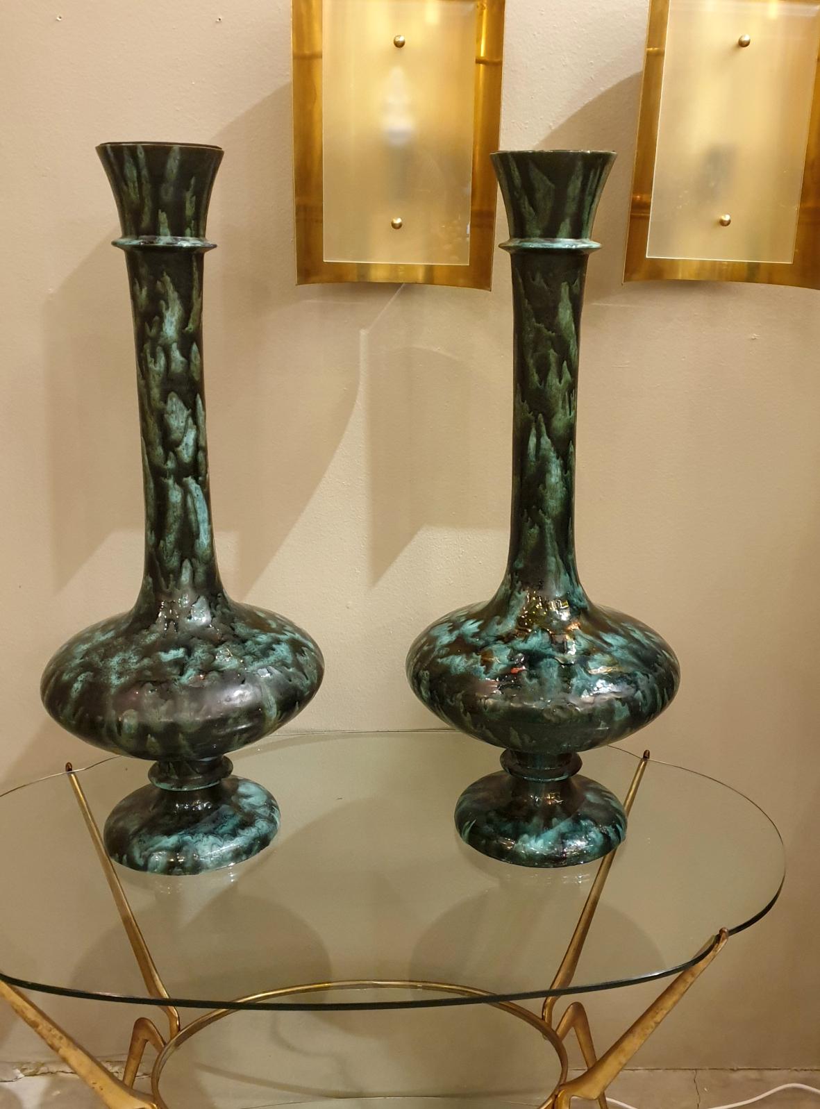 Pair of large and tall urns or Amphora vases, Mid-Century Modern, Italy, 1960s.
The pair of vintage Italian vases have dark green hues and black colors, with a metal part inside the top of each vase.
Beautiful elegant Amphora shape for these