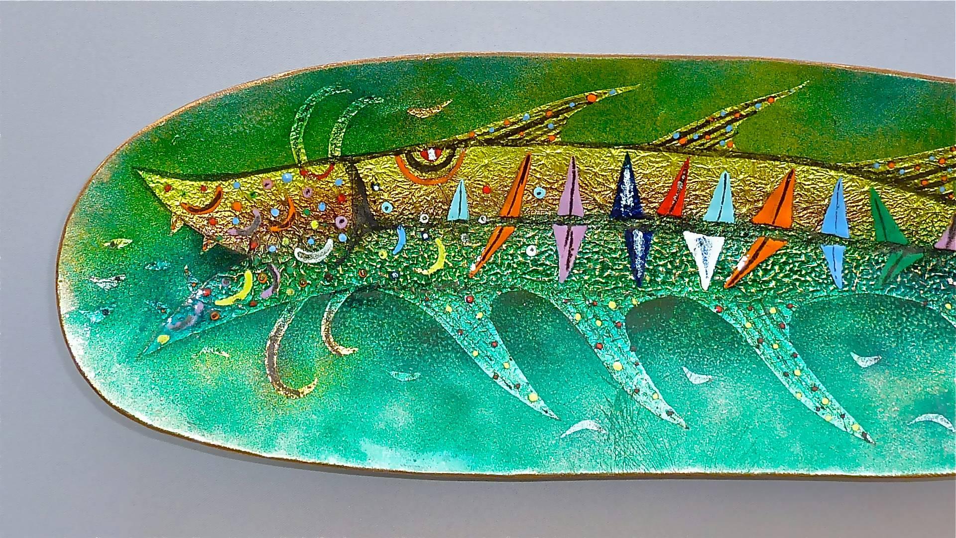 A heavy, elongated colorful enamel on copper bowl with fish motive as wall decoration or to put on a table possibly designed by Paolo De Poli or circle, Italy 1950s. The enamel colors used in the front are green, red, blue, orange, yellow, blue and