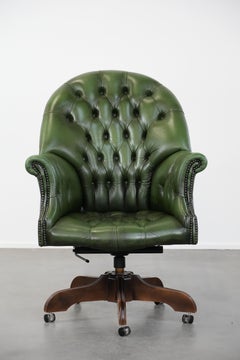 Large green cowhide Chesterfield office chair in English style on wheels