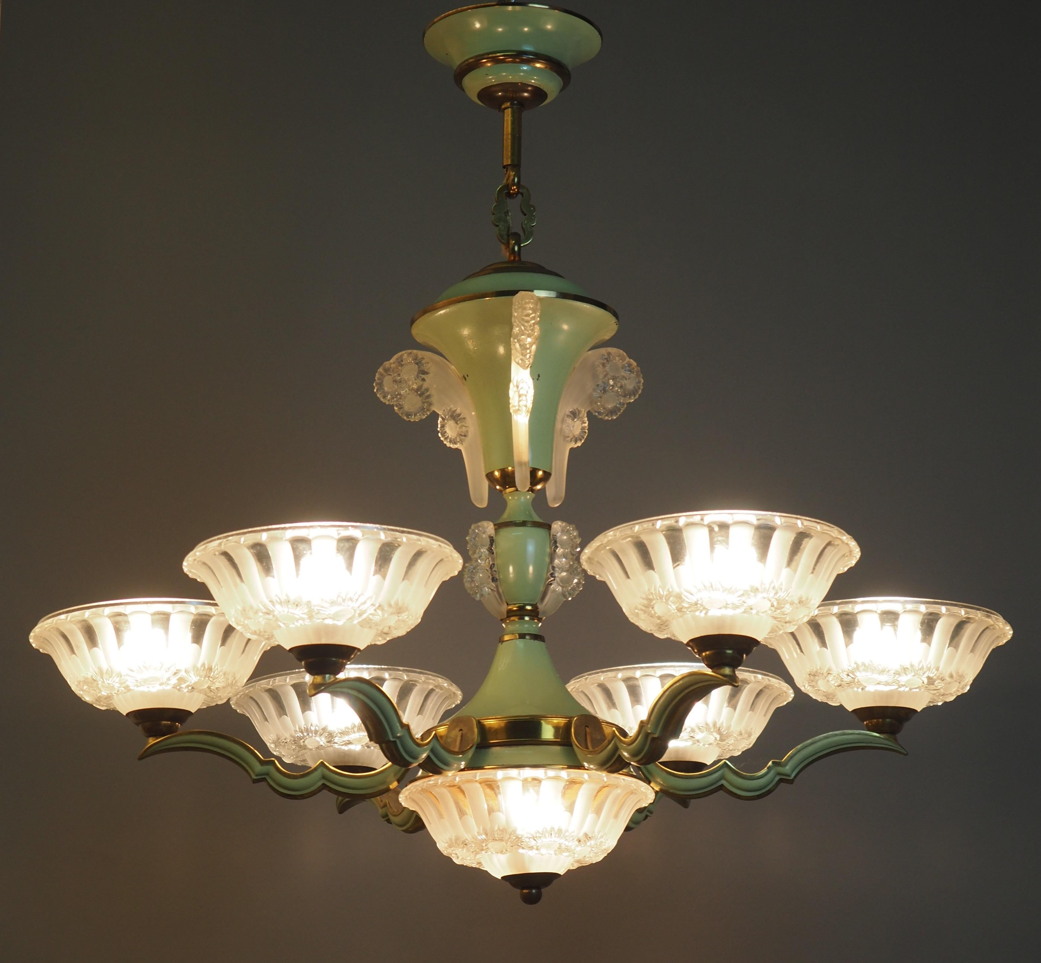 A wonderful, very elegant and stunning art deco six-arm chandelier by EZAN, France, circa 1930s.
The chandelier is made of solid green enameled bronze and thick glass elements.
The fixture takes nine x B22 bulbs (French bajonnett) for