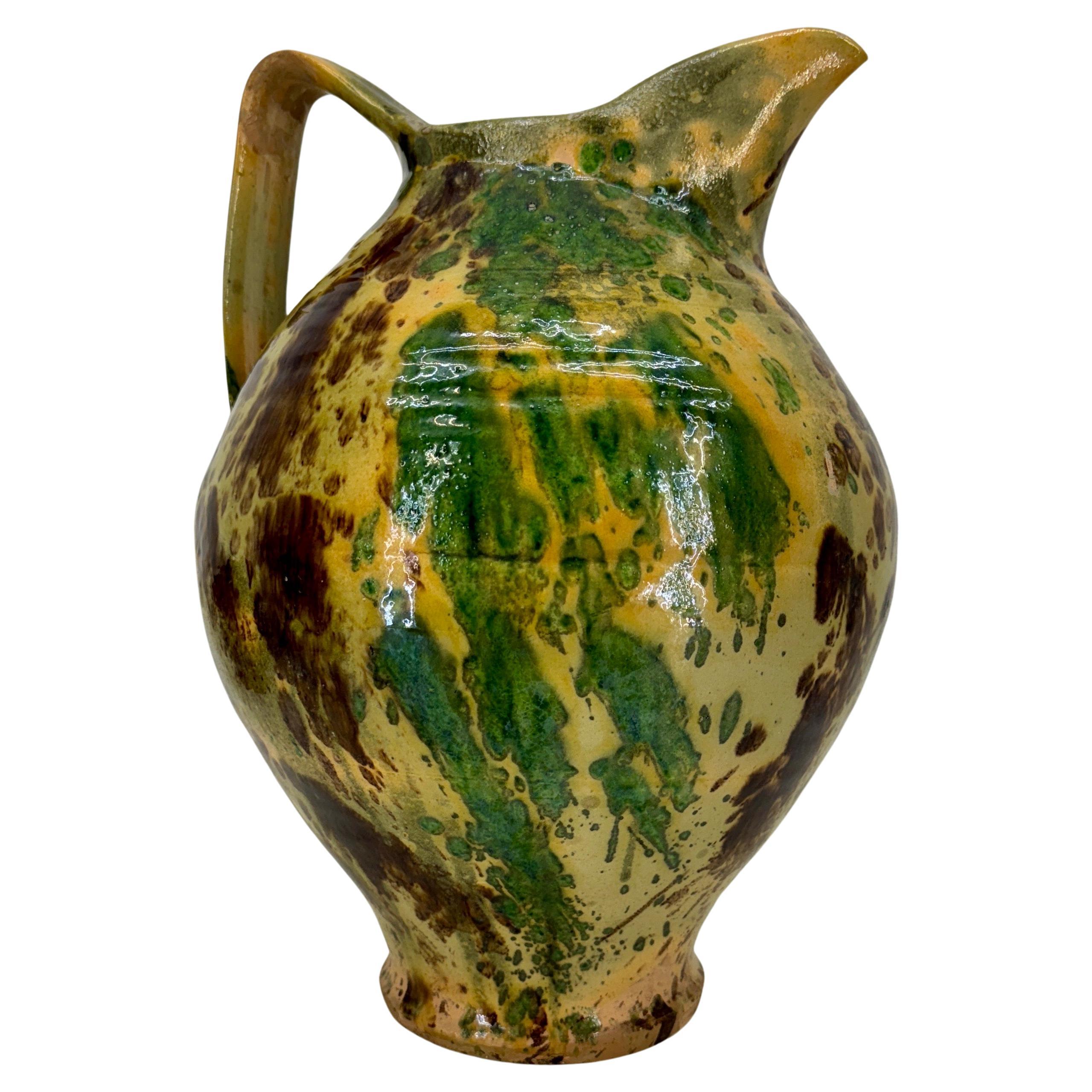 Antique Pottery Jaspe Multicolored Pitcher with Handle, France

Large French pitcher in terracotta with yellows, browns and greens with a marbleized glaze. The pottery piece has one large handle, oversized spout and expresses a lovely glazed finish