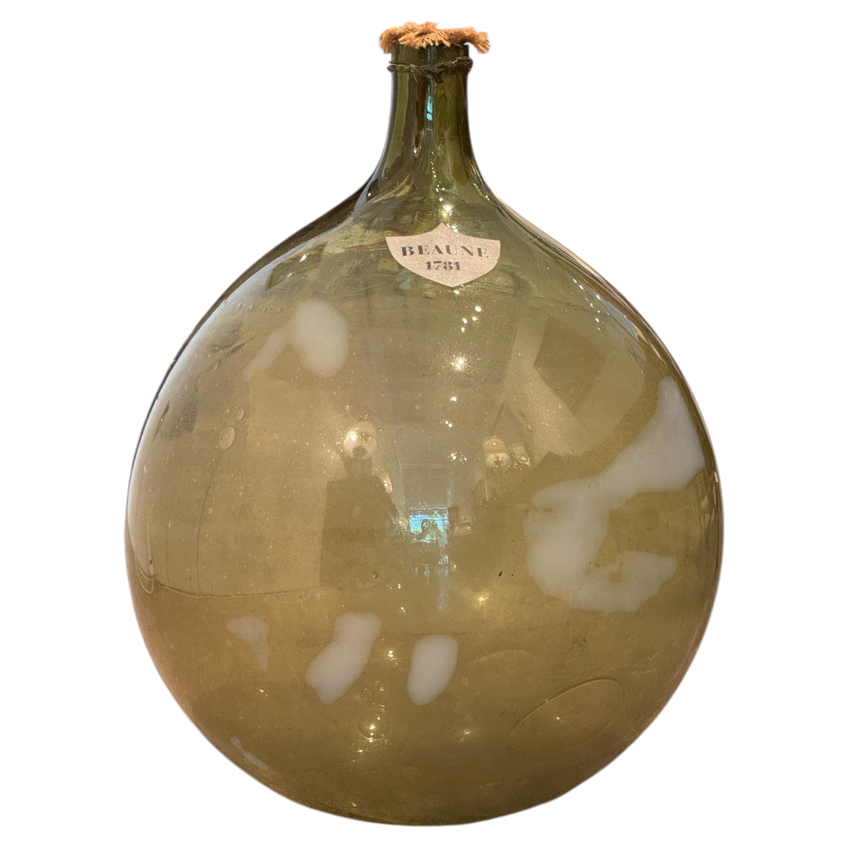 Grande bonbonne en verre vert, labellisée Beaune 1781 en vente