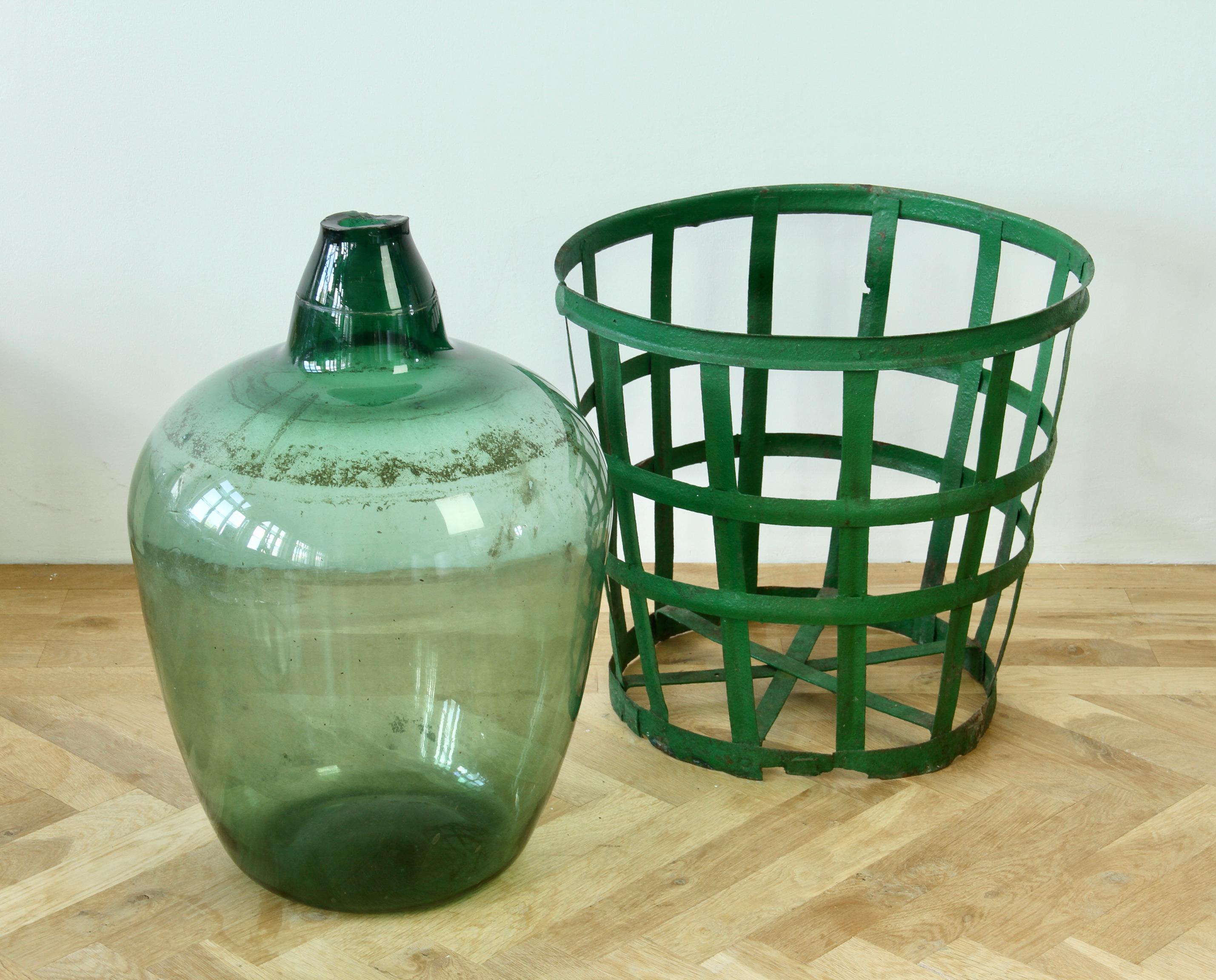 Grande damigiana, anfora o vaso ungherese in vetro verde con cesto originale in ferro in vendita 3