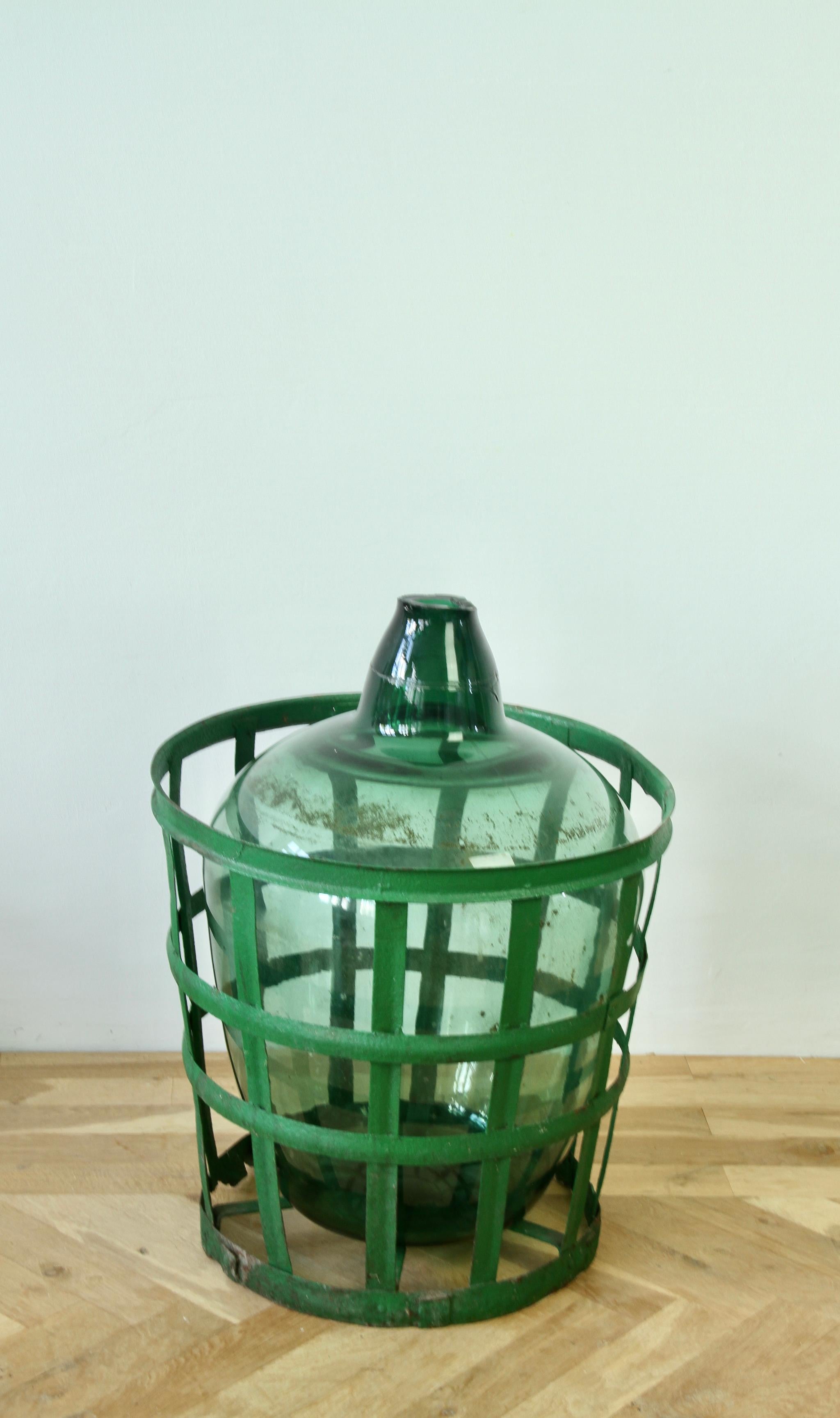Industrial Large Green Glass Hungarian Demijohn, Amphora or Vase with Original Iron Basket For Sale