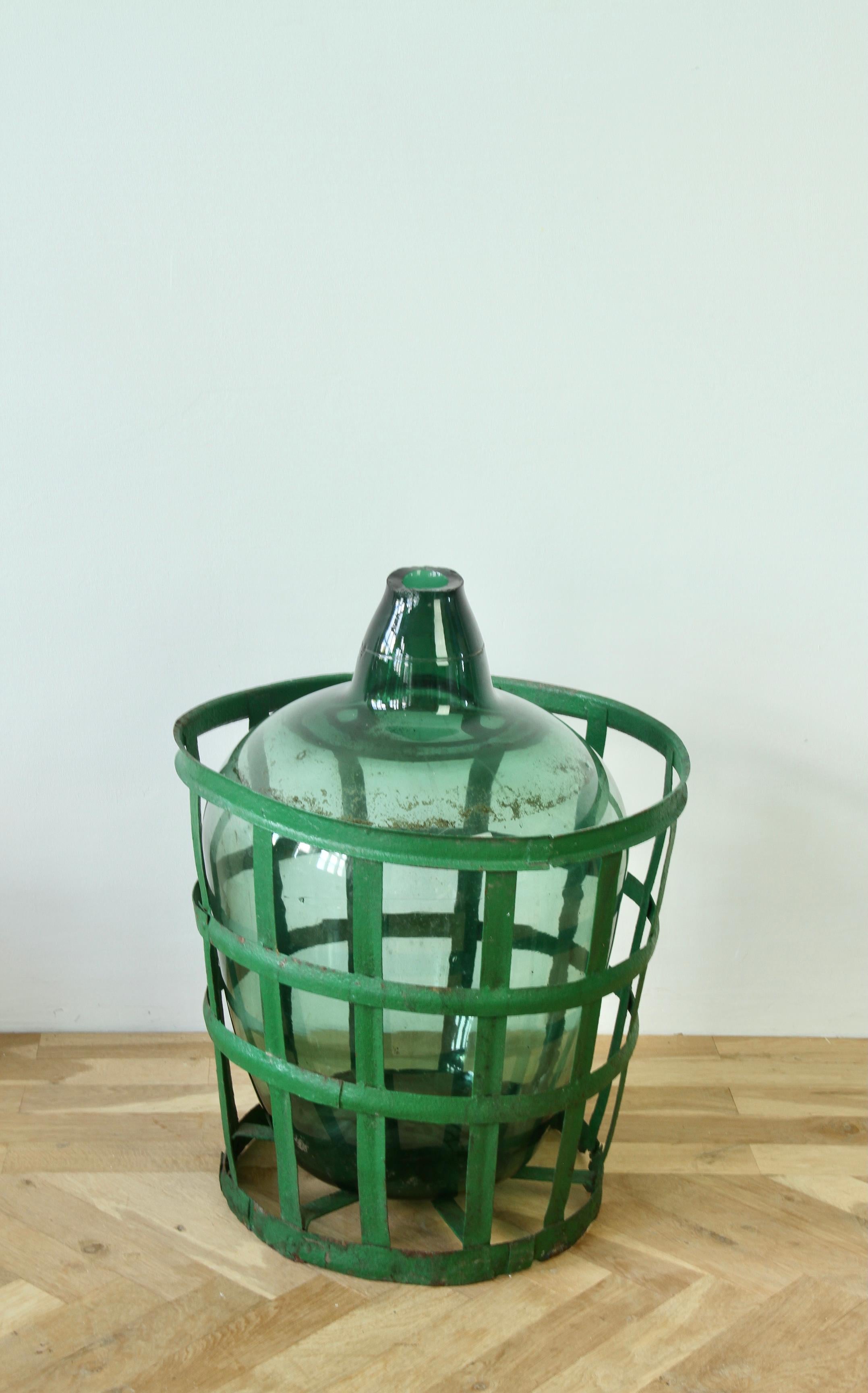 Blown Glass Large Green Glass Hungarian Demijohn, Amphora or Vase with Original Iron Basket For Sale