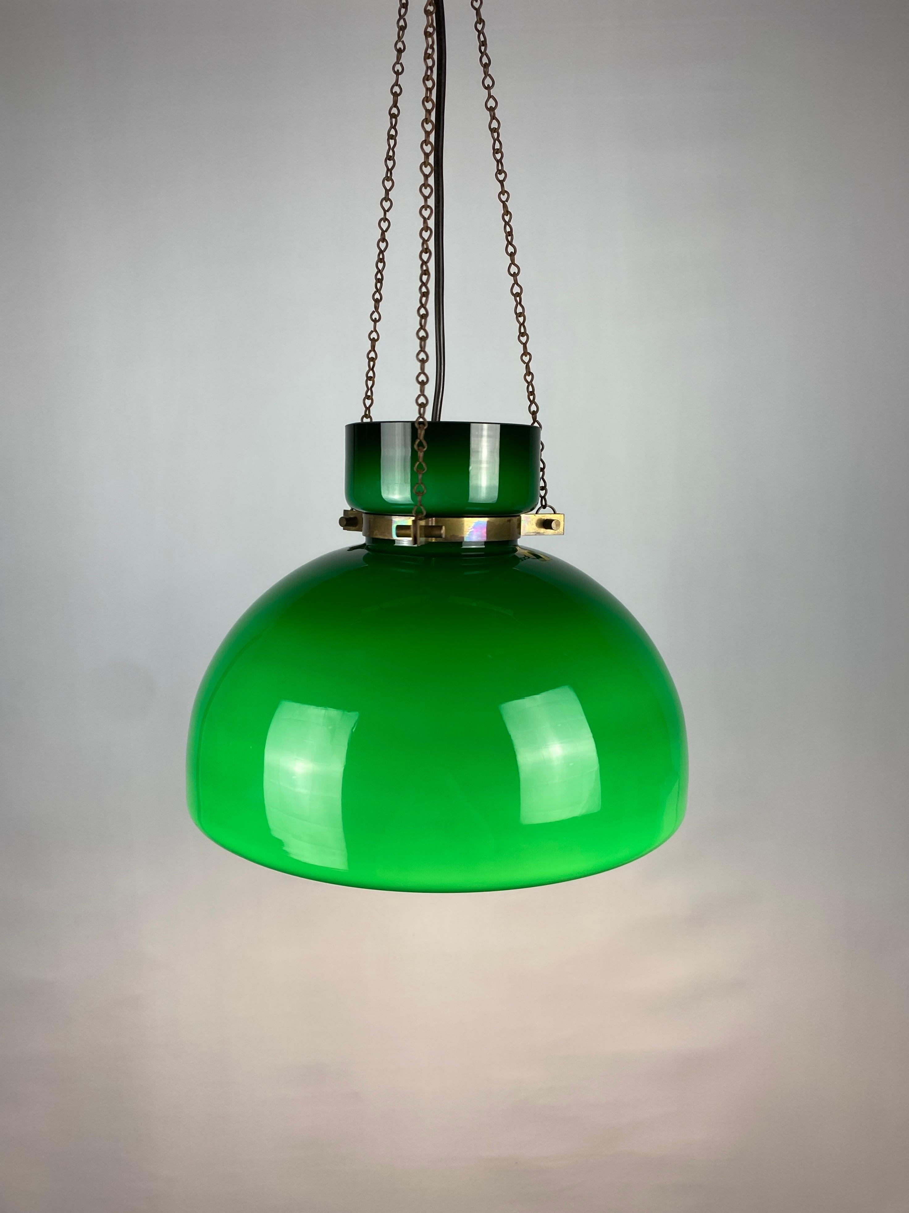 Beautiful dark green opaline glass pendant light by Glashütte Limburg from the 1970's designed by Herbert Proft. 

The green glass shade is held in place by a brass ring which leads to three chains that are mounted at the top to three hooks. The
