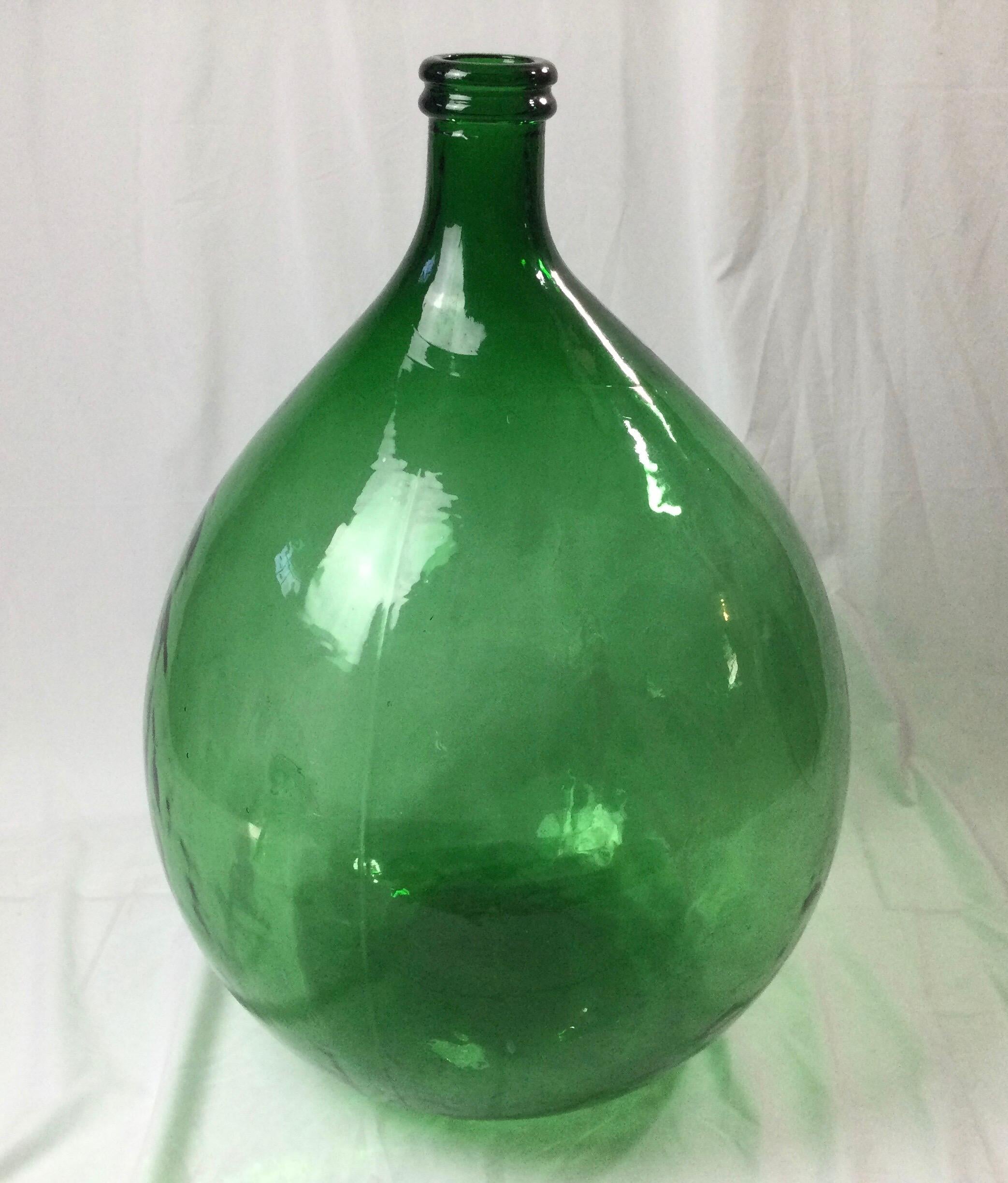 Nice large size about 18” in diameter and 25” tall. Great green color with air bubbles in the glass. Some wine residue on bottom. Age appropriate wear to bottom.