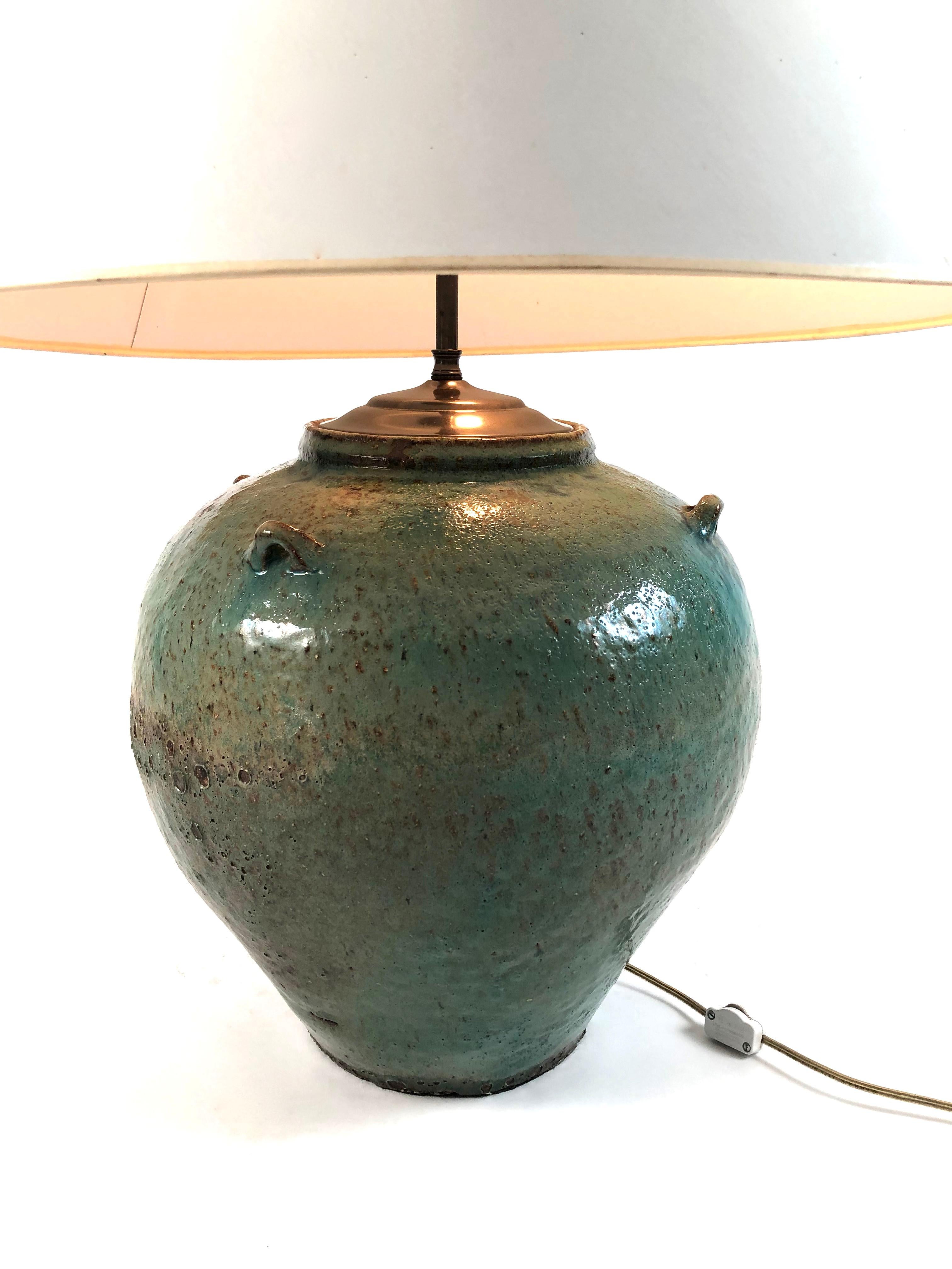 A beautiful and large handmade celadon green, blue and tan glazed art pottery lamp, possibly Japanese, with mottled surface, the high shoulders with four small decorative loop straps. New antiqued bronze metal fittings at the top and new