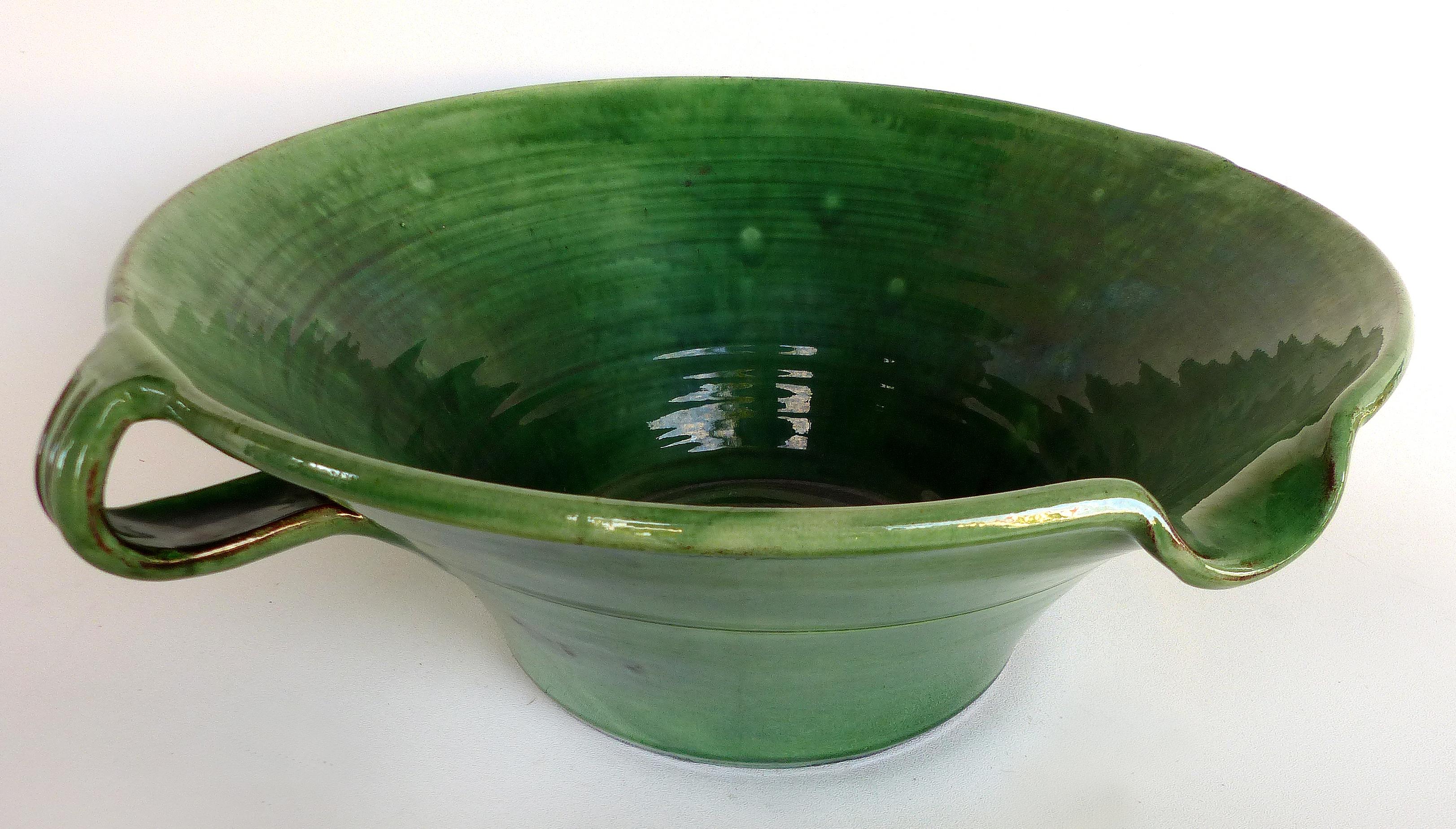 Large Green Glazed French Terracotta Two Handled Vessel with Spout

Offered for sale is a large French glazed green terracotta vessel that was created as a mixing bowl with a pouring spout. The bowl will make a lovely centerpiece for a rustic table