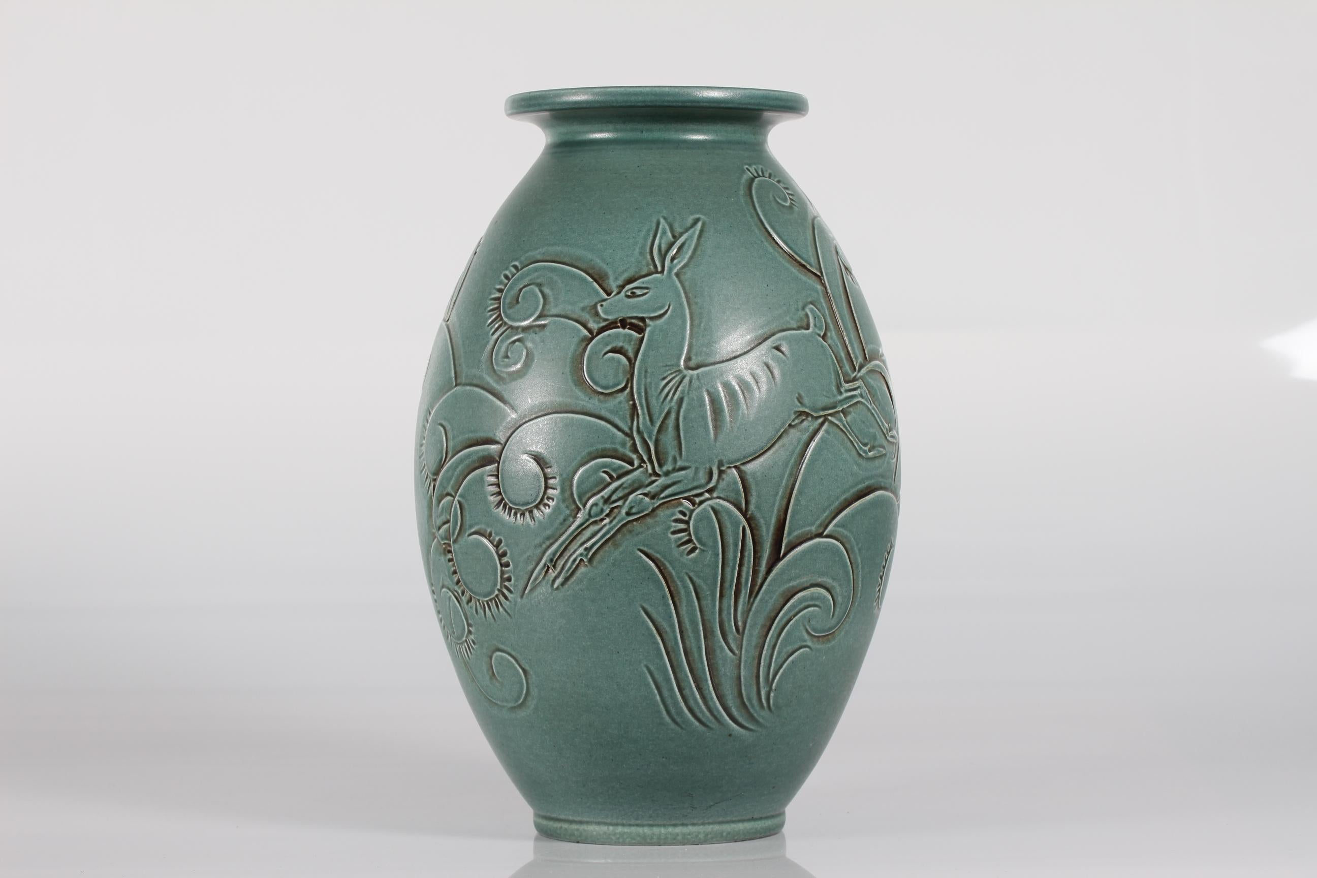 This huge Danish ceramic floor vase is designed by Aksel Sigvald Nielsen (1910-1989) signed as AKSINI, and made by Knabstrup ceramic in the middle of the 20th century.

The vase has a green satin glaze and a young deer and plant ornaments as a
