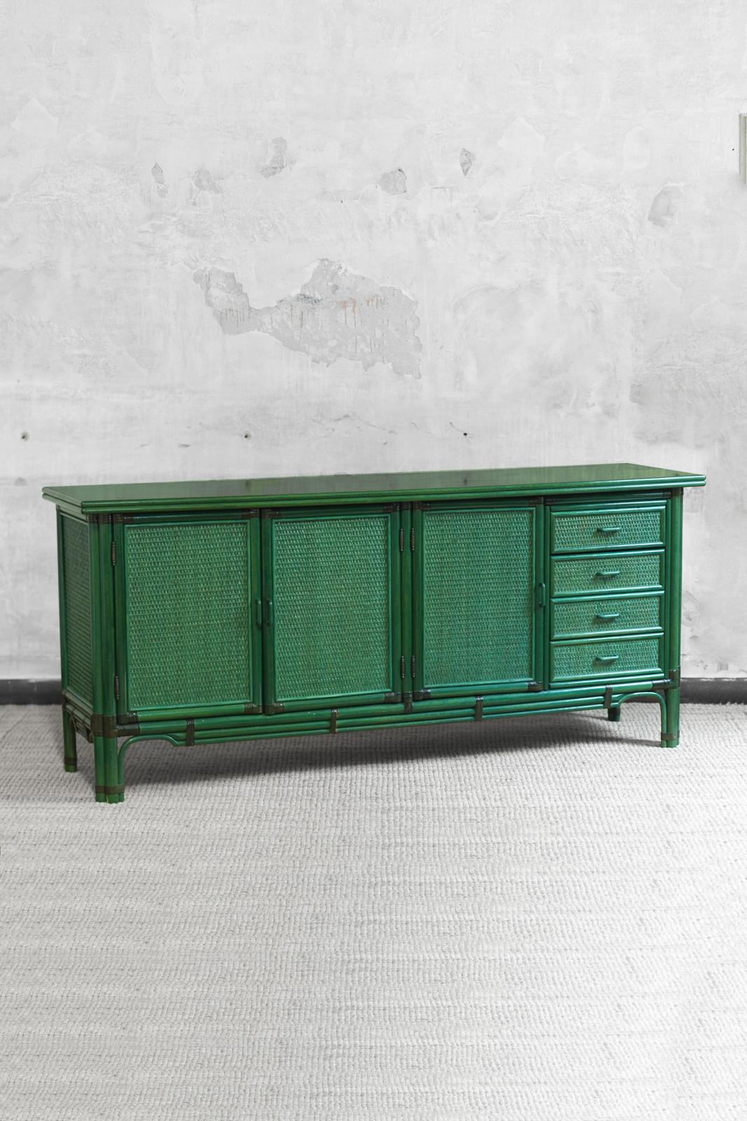 Large green lacquered sideboard, 1980s
Product Details
Large sideboard made of wood, bamboo, and rattan fabric with leather bindings; featuring four drawers and three doors with internal shelves.
Dimensions: 196 L x 86.5 H x 51 D cm