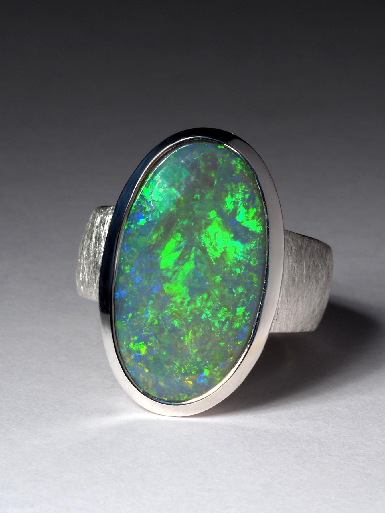 Large Australian Opal ring in silver
weight of the ring - 11.5 gr
width of band increasing from 6 to 9 mm
size of the stone - 13 x 23 mm
size of the ring - circumference 59, N 19, 8.75 US
weight of the opal - 12.10 ct

Worldwide shipping from
