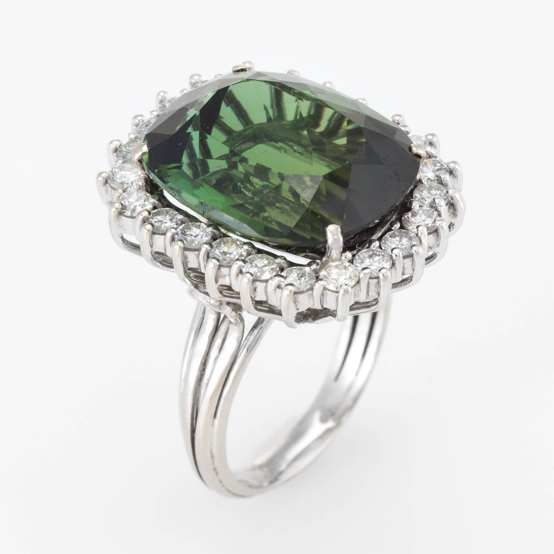 Elegant vintage cocktail ring (circa 1960s), crafted in 14 karat white gold. 

Centrally mounted cushion cut pine green tourmaline measures 18mm x 15mm (estimated at 18.63 carats), accented with an estimated 1.70 carats of round brilliant cut