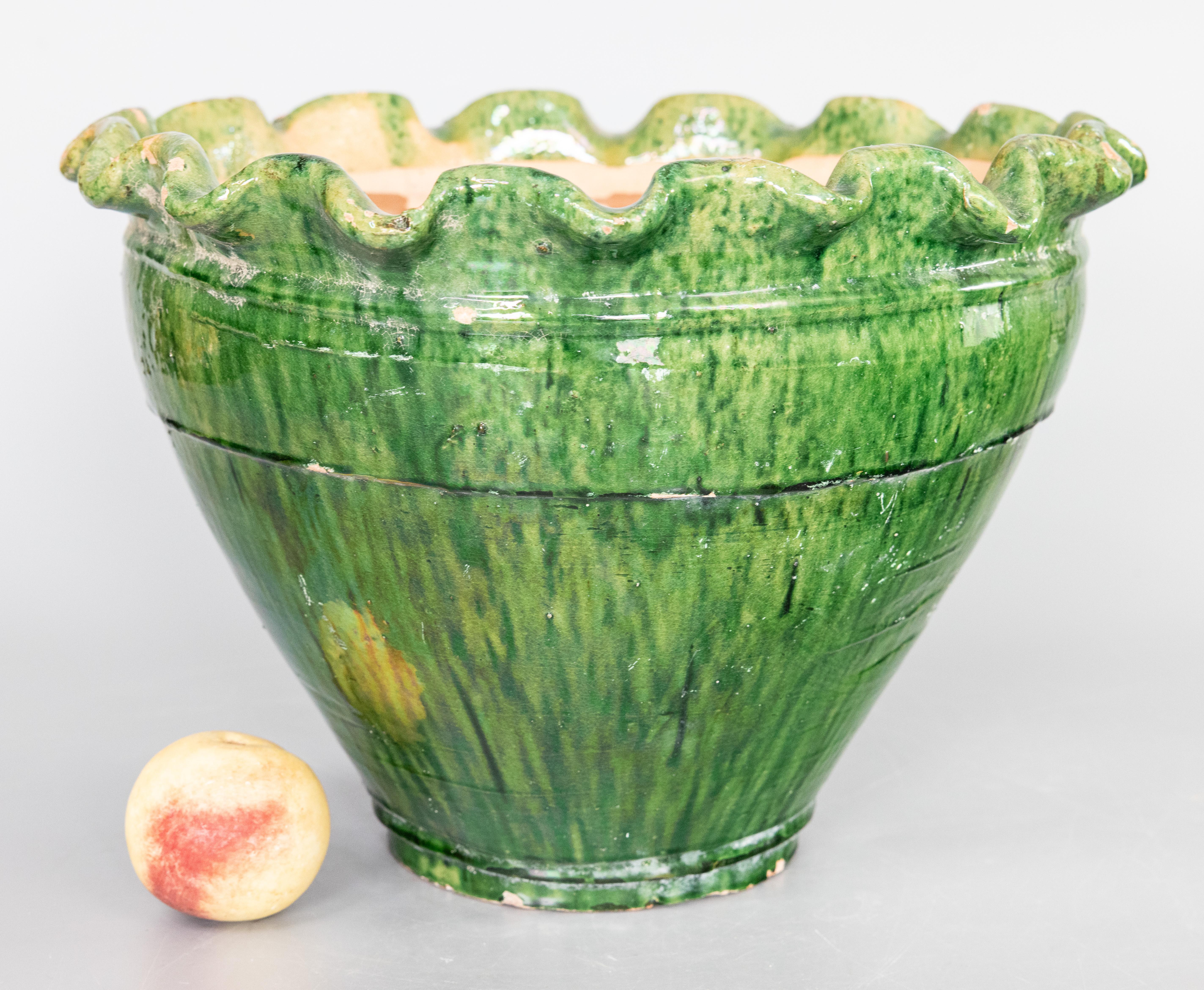 Wonderful large green french terracotta bowl with scalloped pie-crust style rim. Slight iridecence to glaze.