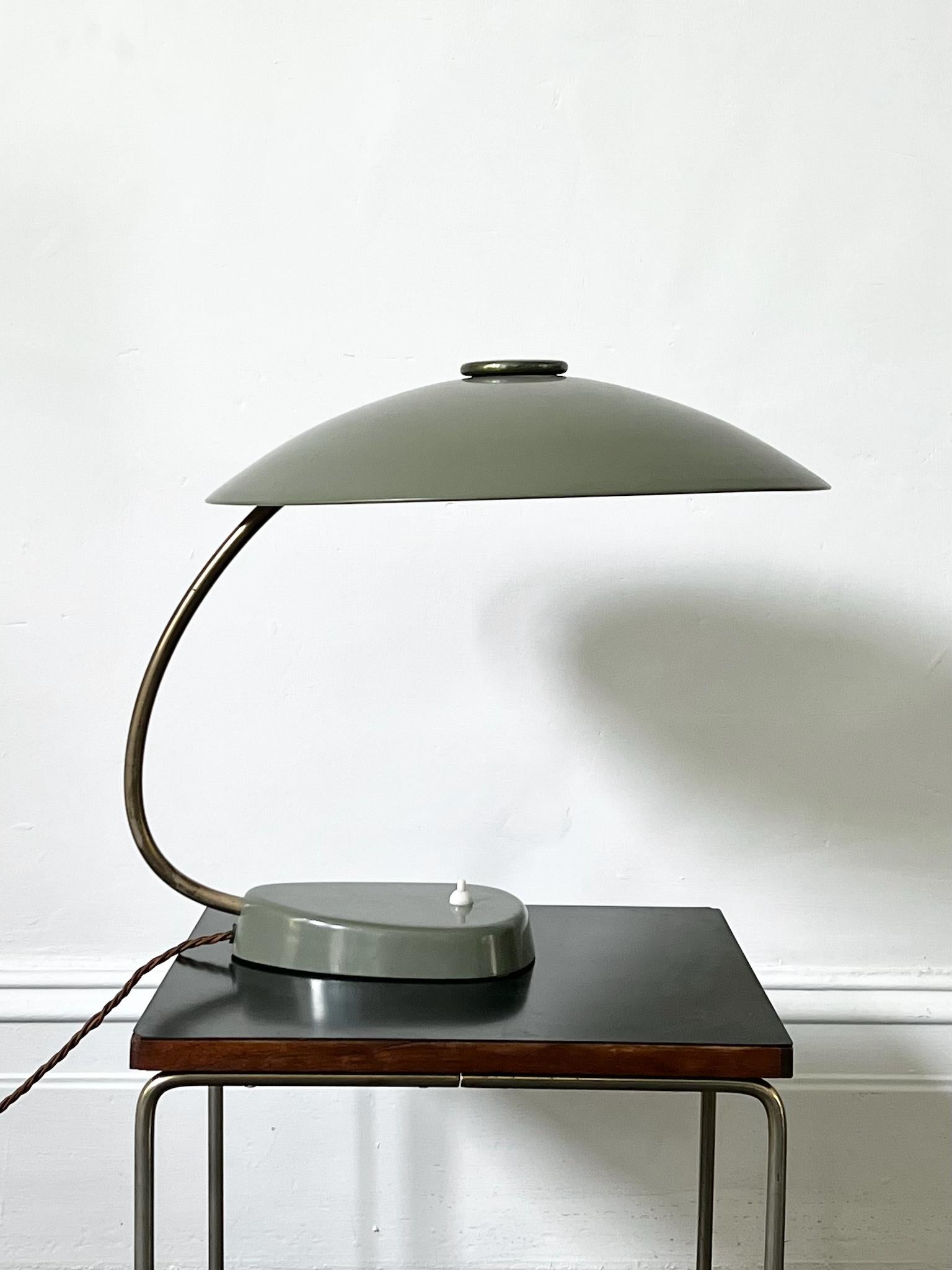 A simple but striking desk lamp with large saucer-shaped shade. Made by LBL dated 1958. 

Unusual to see a lamp of this style in such a large size (approximately 43cm), the shade is French grey (green-grey) on the outside, and white inside, and the