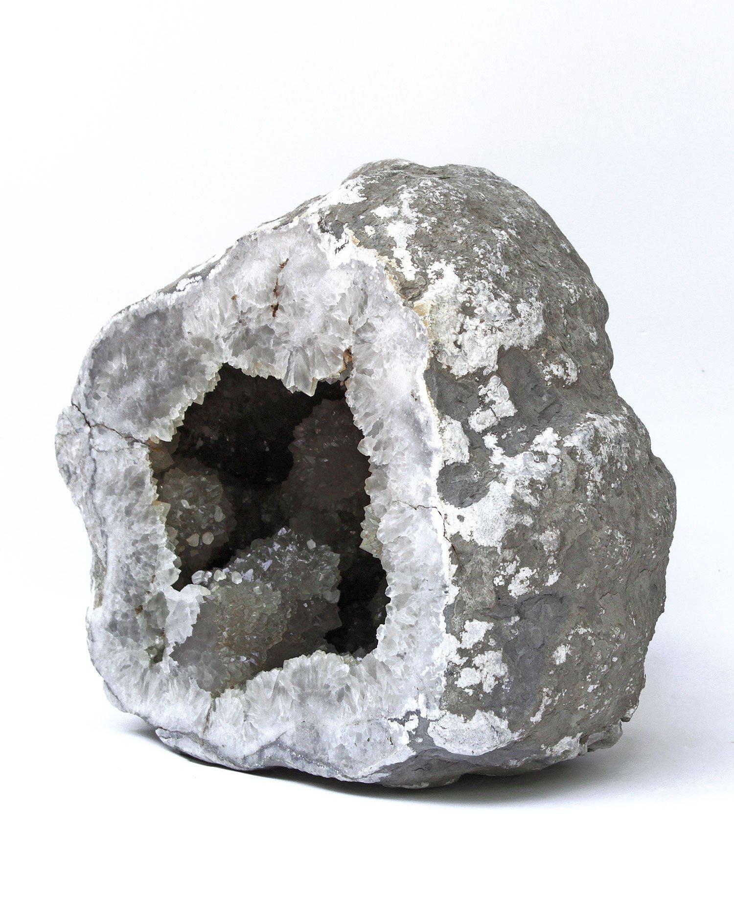 Geode from the Keokuk, Iowa area containing a variety of minerals with a quartz druzy interior. It took around 240 million years to create the beautiful quartz crystals covering the interior walls of the Keokuk geode. The large number of mineral