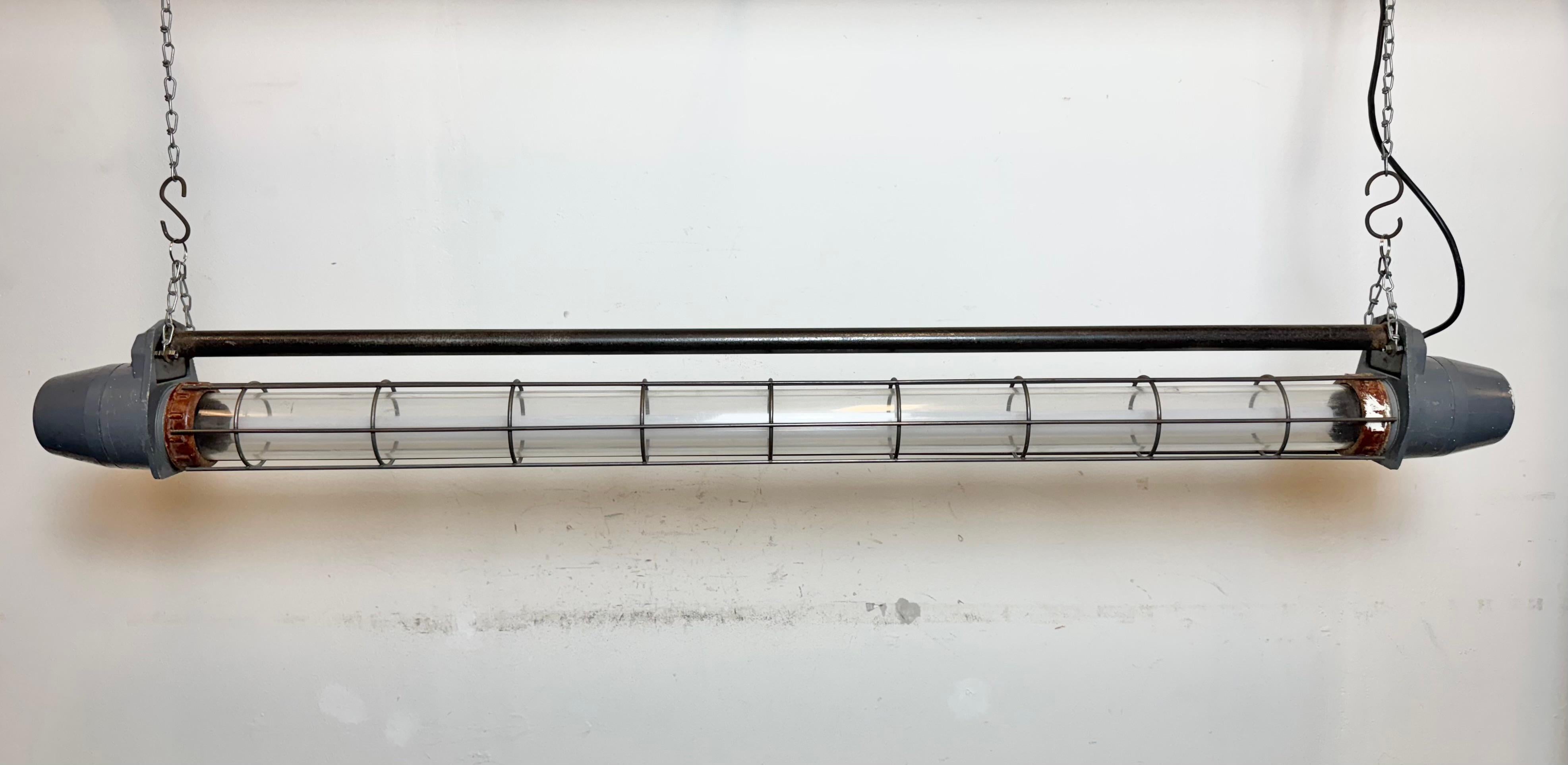 This grey industrial tube light was made in Ukraine in former Soviet Union during the 1970s. It is made of an aluminium, plastic glass and iron .The light is converted into one Led  120 cm T8  light tube.The weight of the lamp is 7 kg. The light
