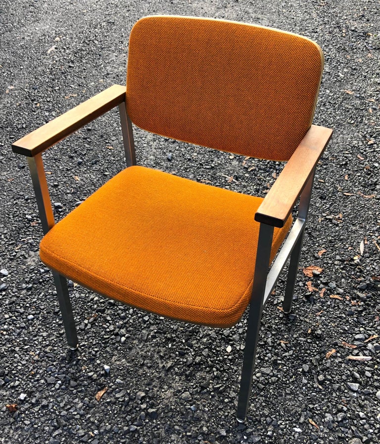 Exceptional large set of approximately 20 chairs, in extraordinary clean, original condition. Stylish, well designed, solid, sturdy, ready to use. Orange tweed fabric, with protective plastic trim, squared steel frame and solid wood arm rests. The
