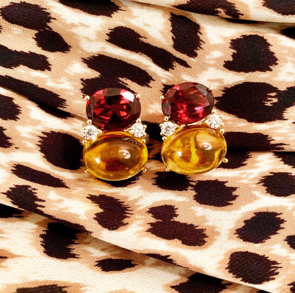 18kt Yellow Gold Large GUM DROP™ Clip Earrings with faceted Garnet and Cabochon Citrine and diamonds.

The Citrine is approximately 5 cts each and the Cabochon Citrine is approximately 12 cts each, and 4 diamonds weighing approximately 0.60cts

The