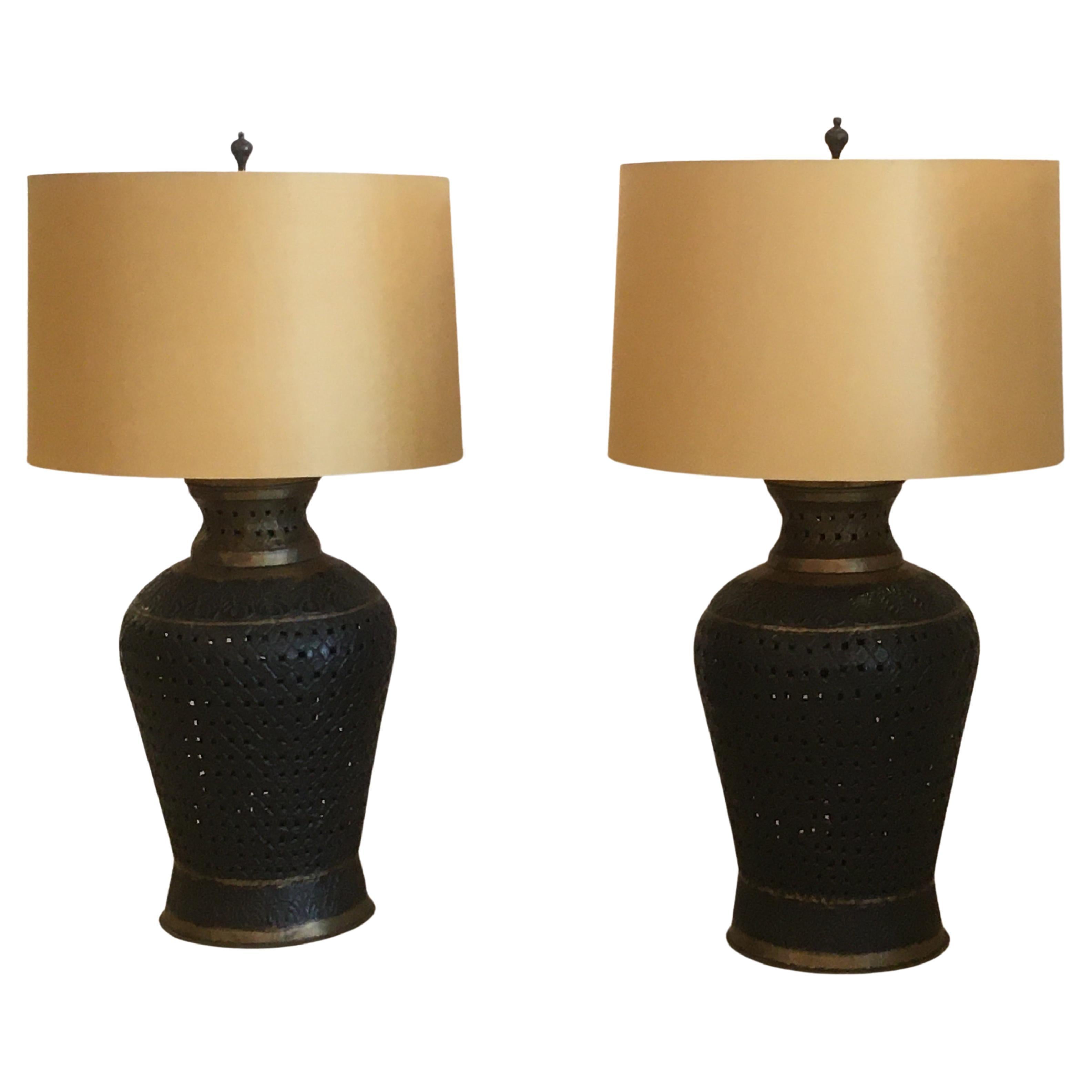 Big gutsy pair of pierced metal table lamps in a handsome shade of brown with gold accents. Have an imported exotic and masculine feel. 
Shade 30