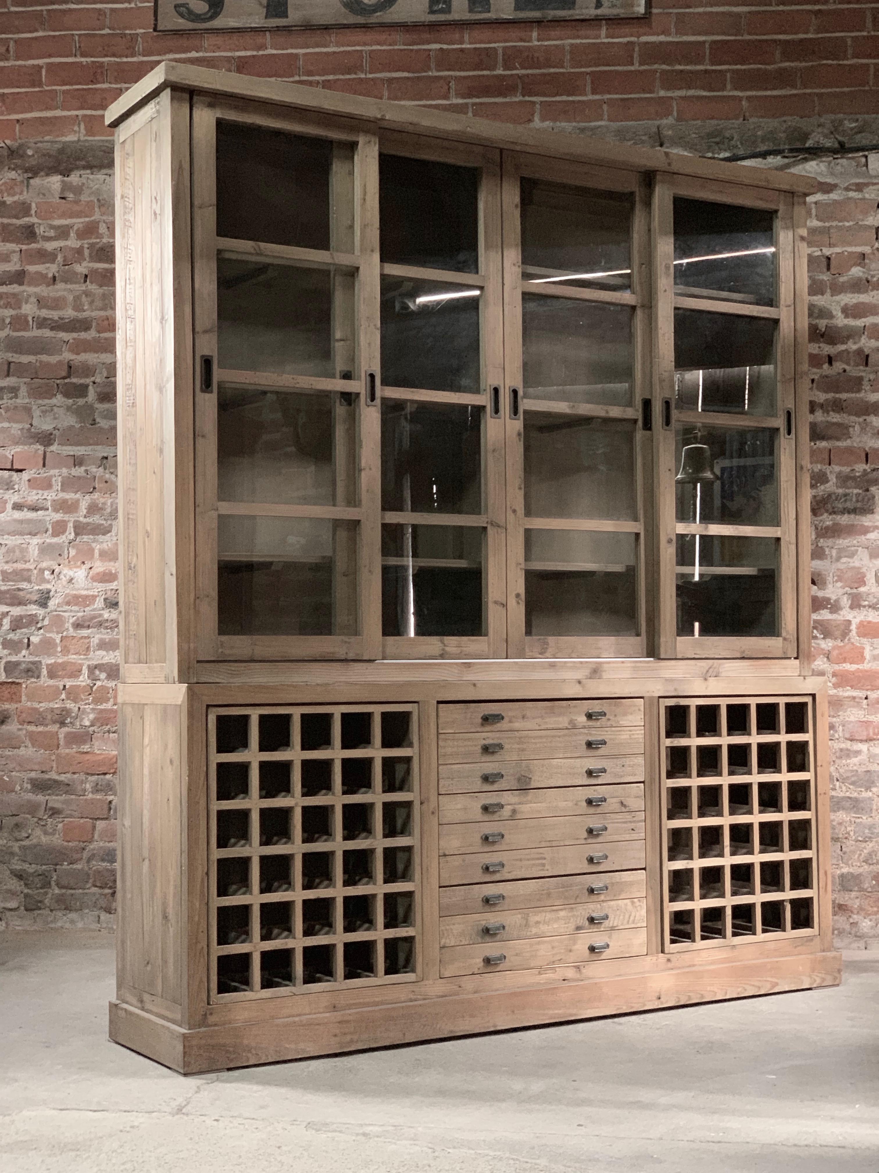 Large Haberdashery kitchen display cabinet pantry solid pine, 20th century

Fabulous large rustic haberdashers style pine display cabinet late twentieth century, the upper section with four tall sliding glazed cabinet doors with three internal